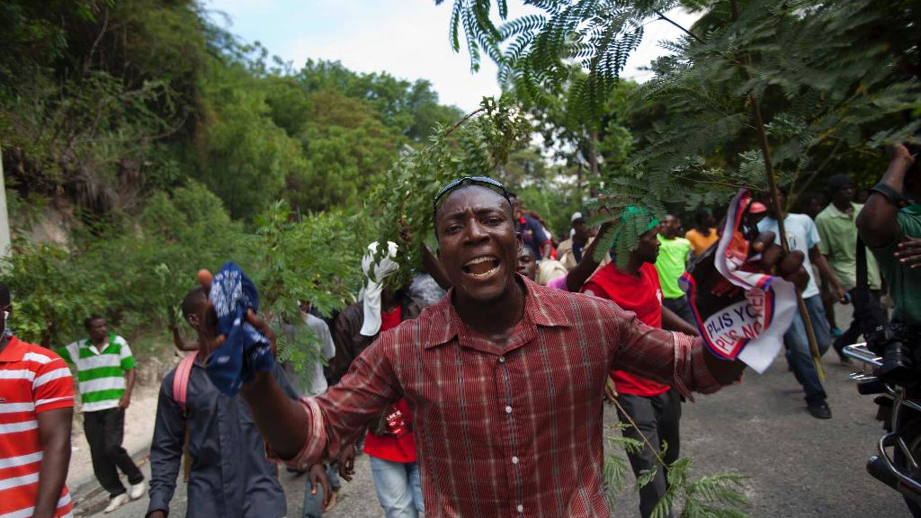 Demonstrators march during an anti-government protest in Port-au-Prince, Haiti, Sunday, Oct. 26, 2014. A few thousand protesters allied with Haiti’s opposition marched through neighborhoods of the capital demanding the chance to vote in legislative and local elections that are three years late, among other grievances. (AP Photo/Dieu Nalio Chery)
