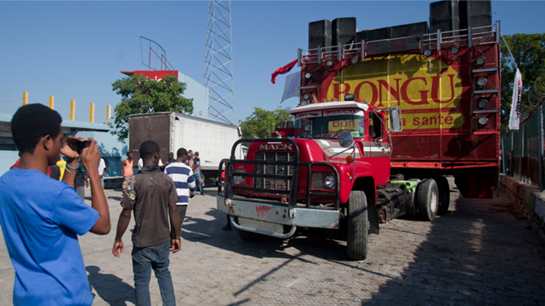 Feb. 17, 2015: A man takes pictures of the float on which a singer was electrocuted by an overhead power line as the float passed beneath it during a carnival parade in Port-au-Prince, Haiti. At least 20 people were killed early Tuesday after he was electrocuted, setting off a panic in which dozens of people were trampled, witnesses and officials said.