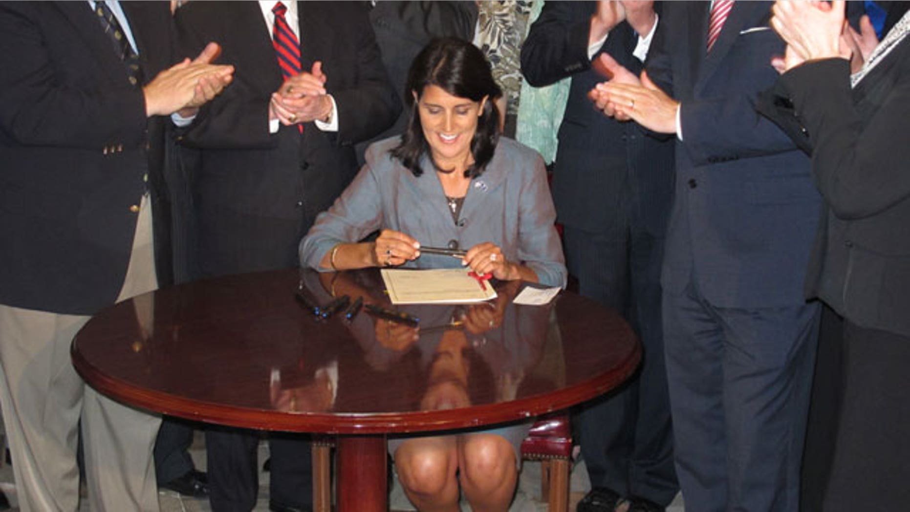 South Carolina Gov. Nikki Haley signs a bill that requires the state's General Assembly to record all its votes on budget items and final votes on other legislative matters, April 12,2011. (FNC)