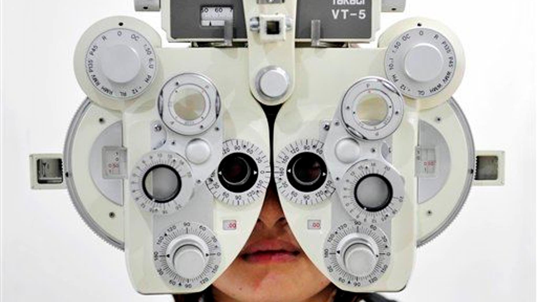 A near-sighted girl receives an eye sight examination.