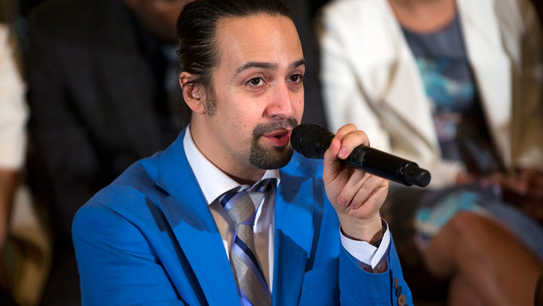 In this March 14, 2016 photo, Actor Lin-Manuel Miranda speaks during an event with the cast of the Broadway play "Hamilton" in the East Room of the White House in Washington. Americas first Treasury secretary says its time for Congress to help dig Puerto Rico out of its debt crisis. And if it will help make the case, hes even got tickets to Broadways latest mega-hit. Alexander Hamilton, actually Lin-Manuel Miranda, who created the show and plays Hamilton, told reporters on Capitol Hill Tuesday that lawmakers must pass legislation that would let the U.S. territory restructure its $72 billion debt. (AP Photo/Evan Vucci)