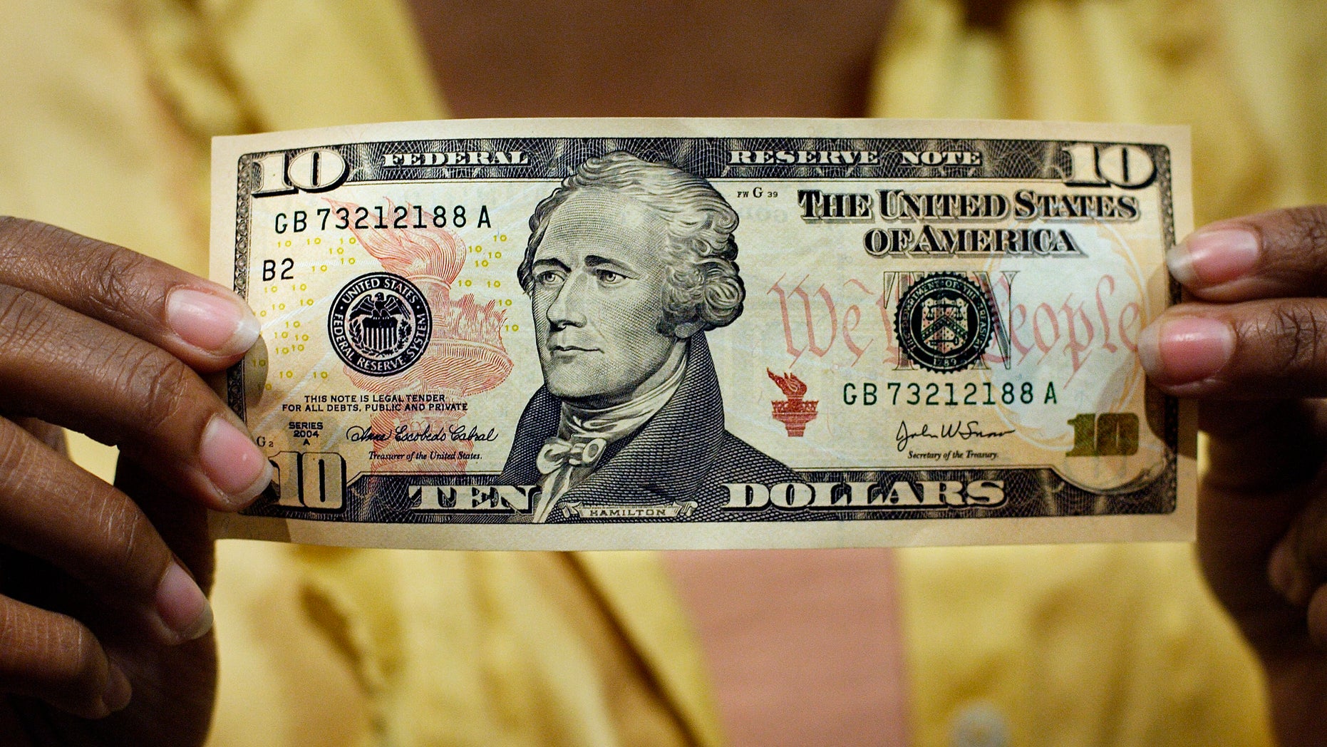 FILE - In this March 2, 2006, file photo, a $10 bill, featuring a likeness of Andrew Hamilton, the first U.S. Treasury secretary, is displayed at the National Archives gift shop, in Washington. U.S. Treasury officials declined to comment Monday, April 18, 2016, on the specifics of a CNN report that Treasury Secretary Jacob Lew has decided to keep Hamilton on the $10 bill, and instead replace seventh U.S. President Andrew Jackson's portrait on the $20 bill with a woman who represents the struggle for racial equality. (AP Photo/J. Scott Applewhite, File)