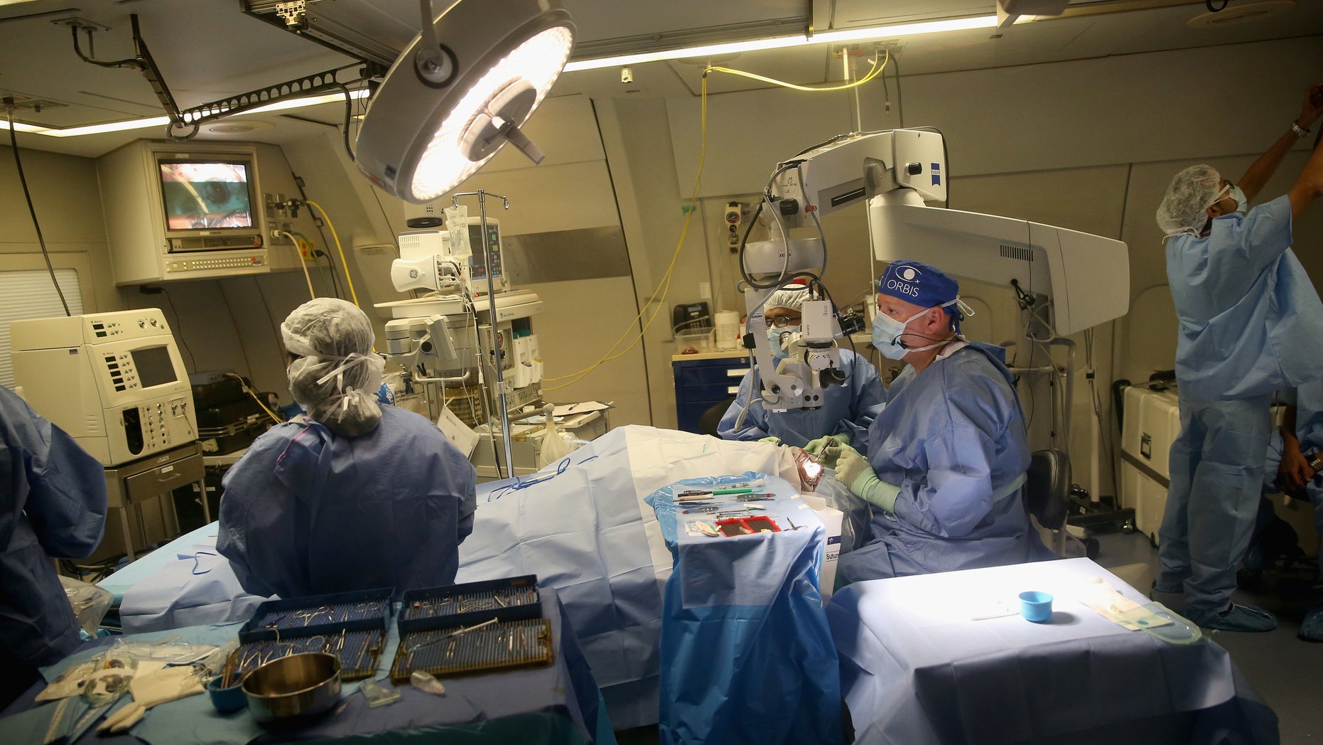 KOLKATA, INDIA - SEPTEMBER 19: (EXCLUSIVE COVERAGE) Dr Roberto Pineda performs a corneal transplant in the operating theatre on the converted DC-10 Aircraft that charity Orbis uses as a flying opthalmic hospital at Kolkata airport on September 19, 2013 in Kolkata, India. During her solo visit to India the Countess is supporting the sight saving charity ORBIS. The Countess witnessed patients' surgery and met patients' during her tour of the plane. She also met medical volunteers from around the world who share their skills with local eye care workers to improve eye care in local communities. (Photo by Chris Jackson/Getty Images)
