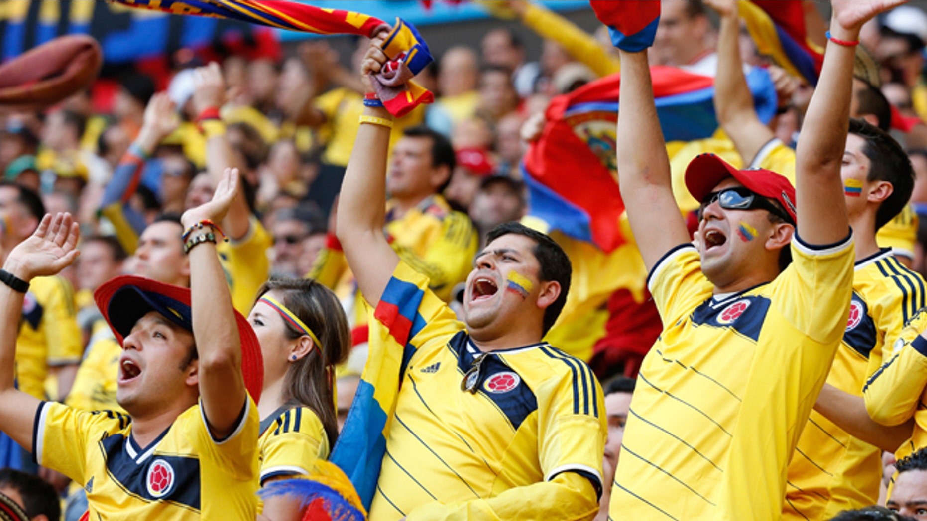 Colombia fans celebrate during a World Cup match on June 19, 2014 in Brasilia, Brazil.