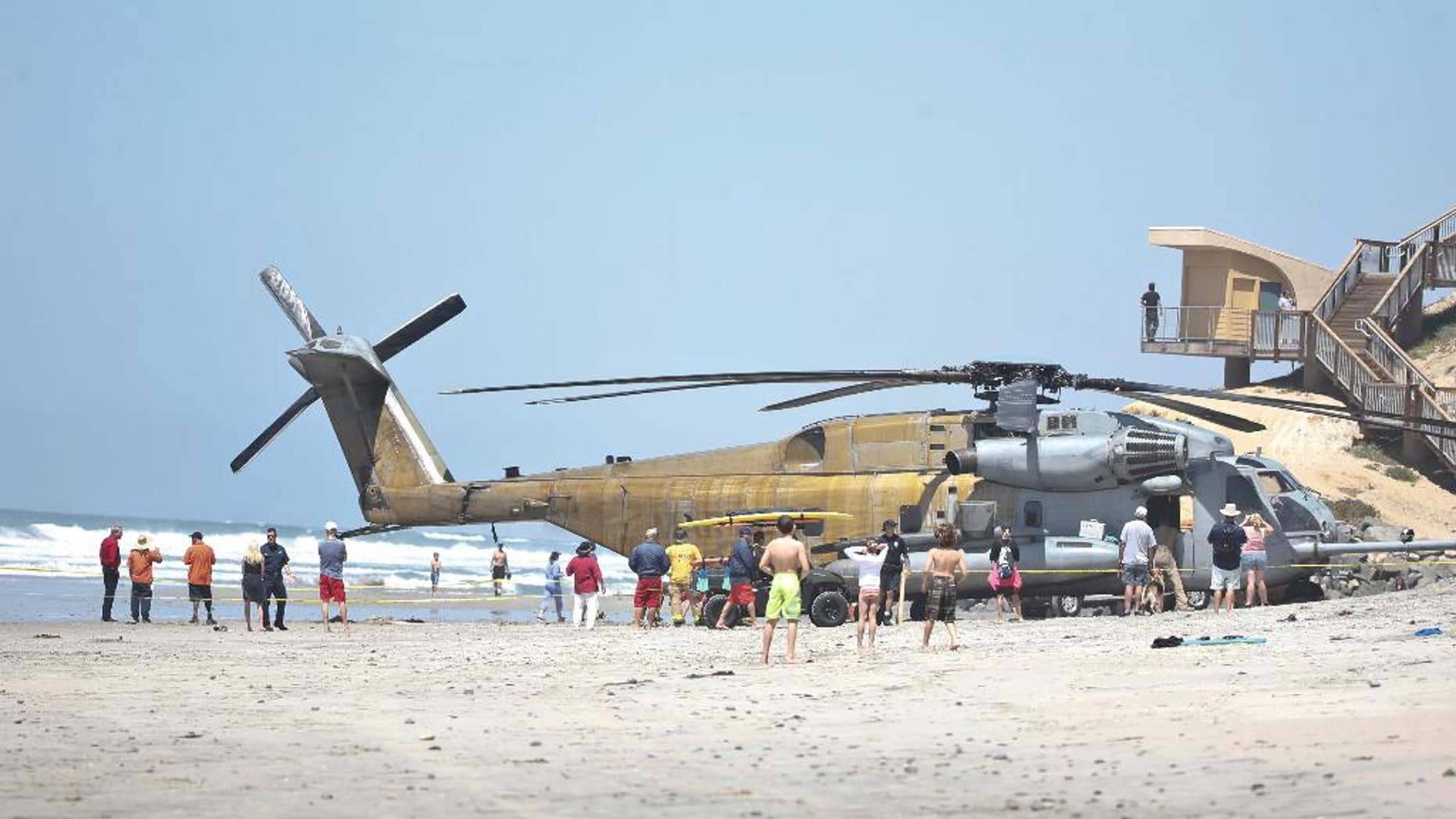 FILE -In this Wednesday, April 15, 2015 file photo, a Marine Corps CH-53E helicopter sits in the sand where it made an emergency landing in Solana Beach, Calif. One Marine has been killed and 9 others were hurt when a helicopter made a hard landing at Camp Lejeune in North Carolina, Wednesday night, Sept. 2, 2015. (AP Photo/Lenny Ignelzi, File)