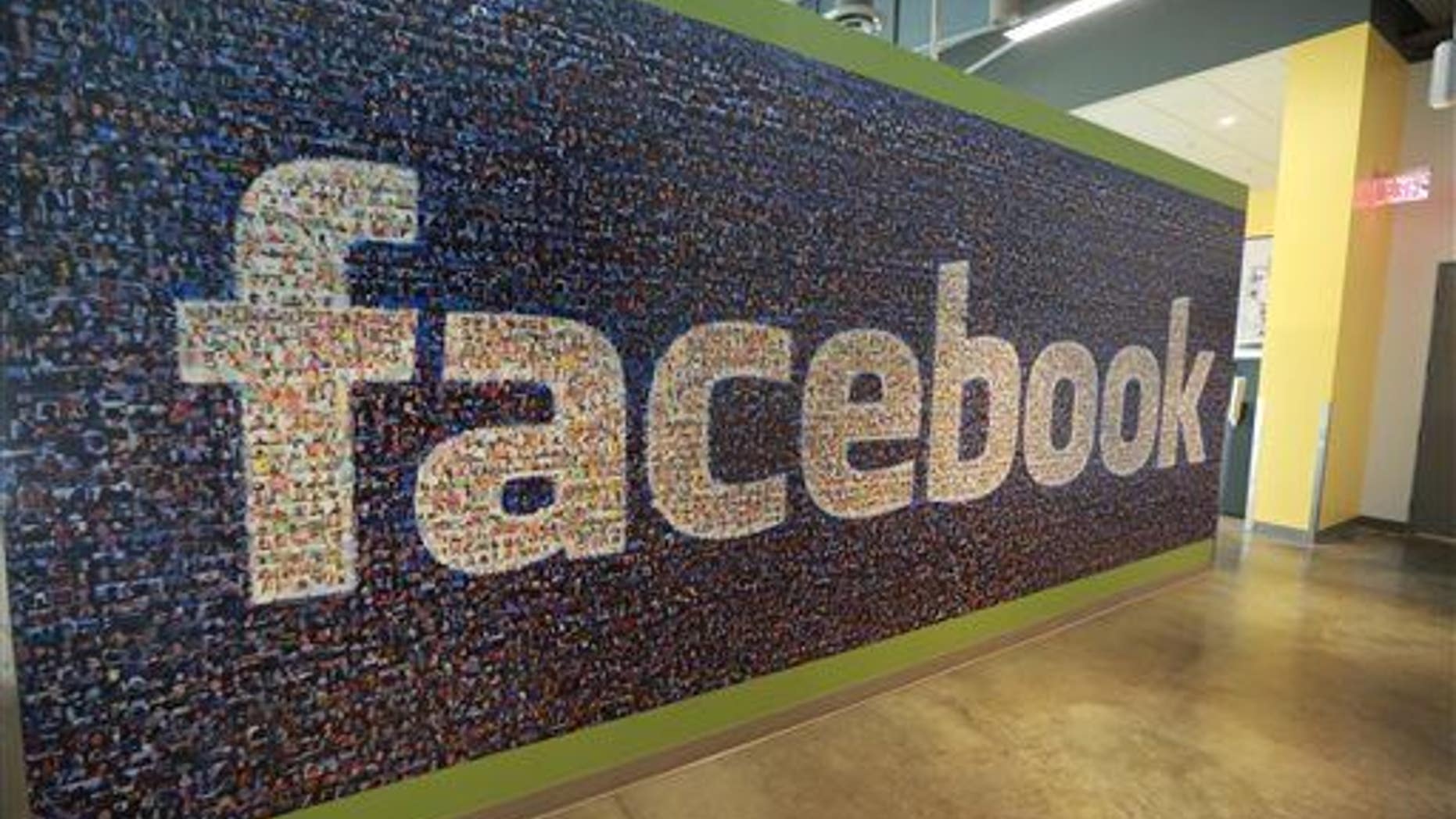 This Nov. 14, 2014, photo shows a board with the Facebook logo inside the new Facebook data centers in Altoona, Iowa.