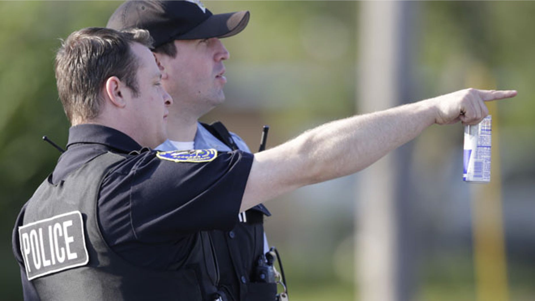 Aug. 20: Police stage at an intersection as law enforcement officials continue to negotiate with at least one hostage-taker for the release of two children and two adults he is still holding inside a house in the southern Chicago suburb of Harvey.