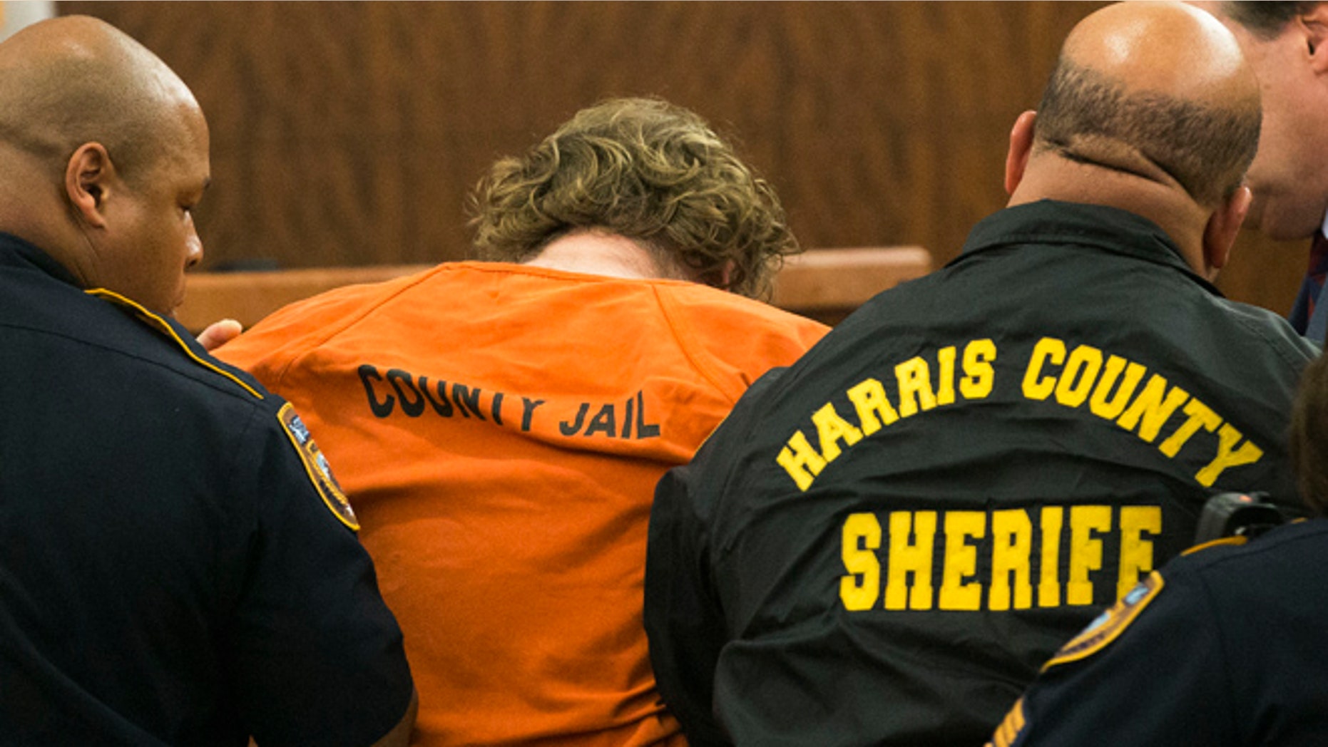 July 11: Ronald Lee Haskell collapses as he appears in court in Houston. Haskell, 33, is accused of killing his ex-wife's sister, Katie Stay, her husband and the children, ranging in age from 4 to 14, after binding and putting them face-down on the floor of their suburban Houston home.