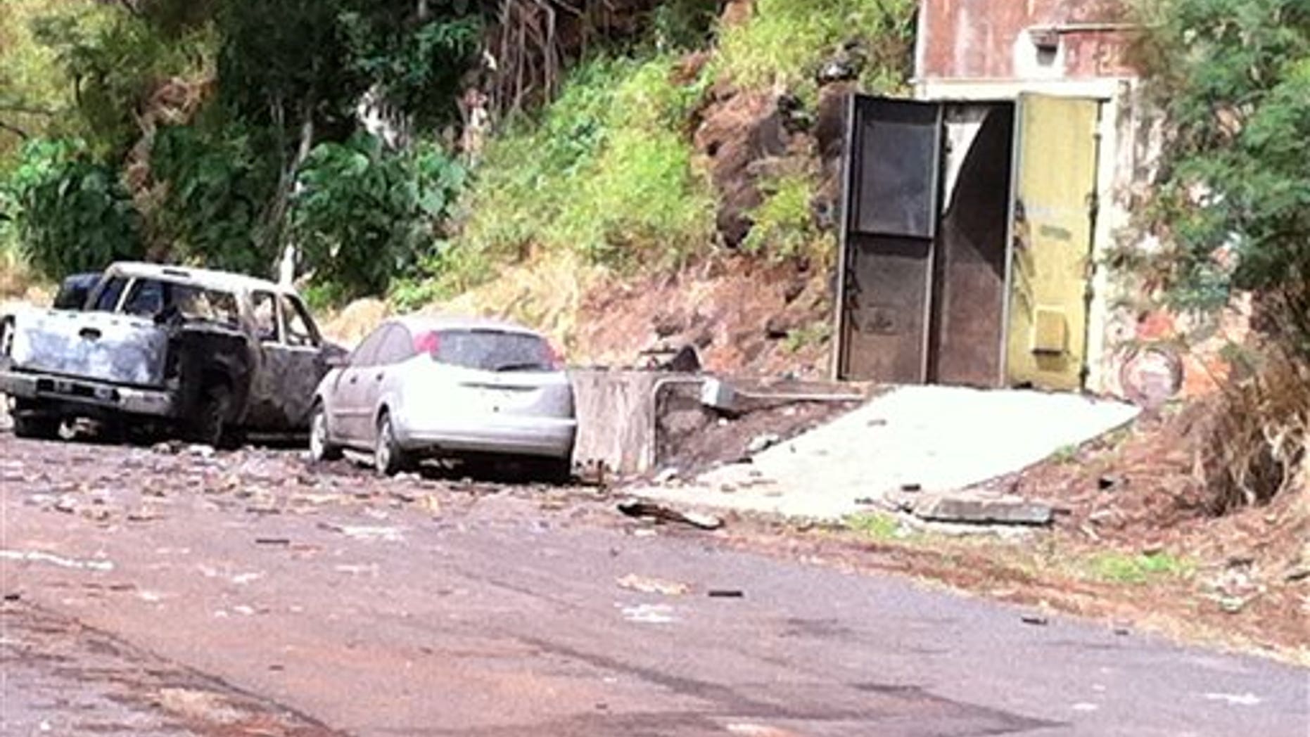 April 8: This image provided by KITV shows the entrance to the bunker where fireworks were stored at Waikele Business Center in Waipahu, Hawaii. At least two men were killed, injuring two others and two are missing after the explosion. (AP/KITV)
