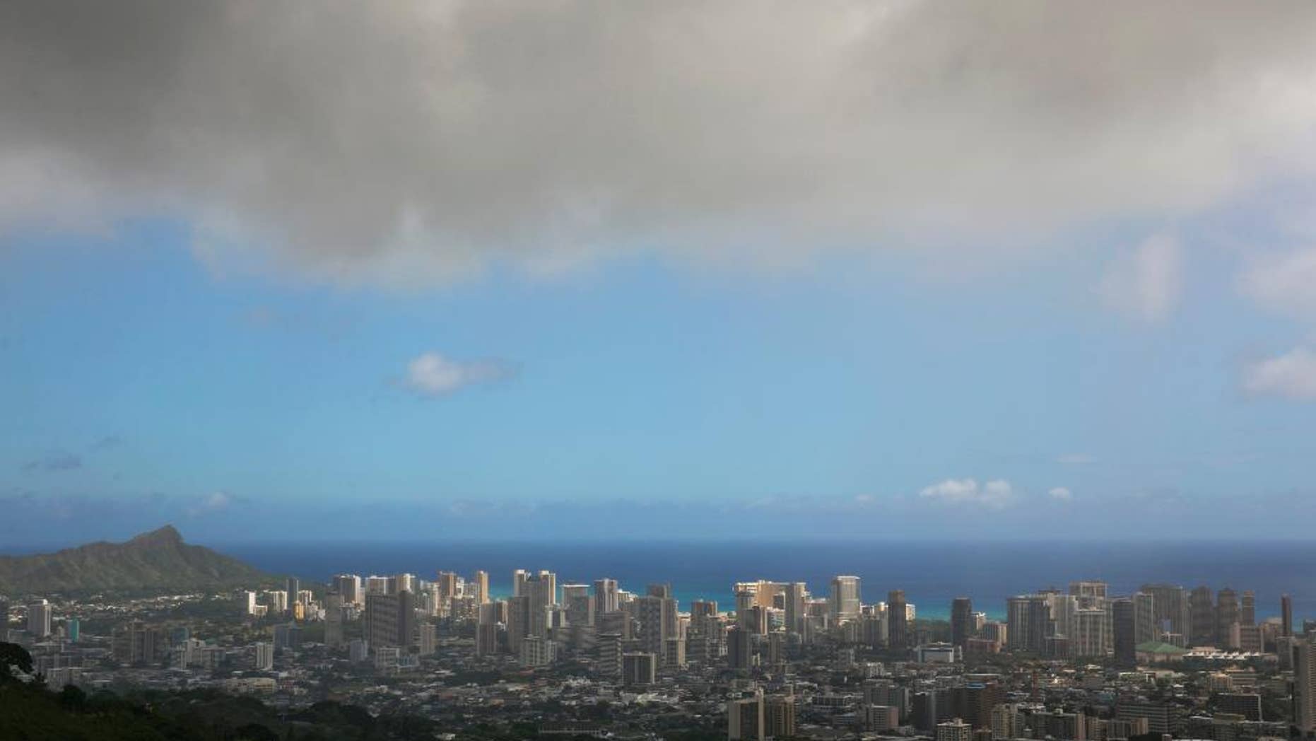 In this Aug. 7, 2014, file photo, clouds hang over Honolulu as Hurricane Iselle approaches. The National Oceanic and Atmospheric Administration's Central Pacific Hurricane Center says the 2015 hurricane season in the region will see more storms than average from June 1 through Nov. 30. (AP Photo/Marco Garcia, File)