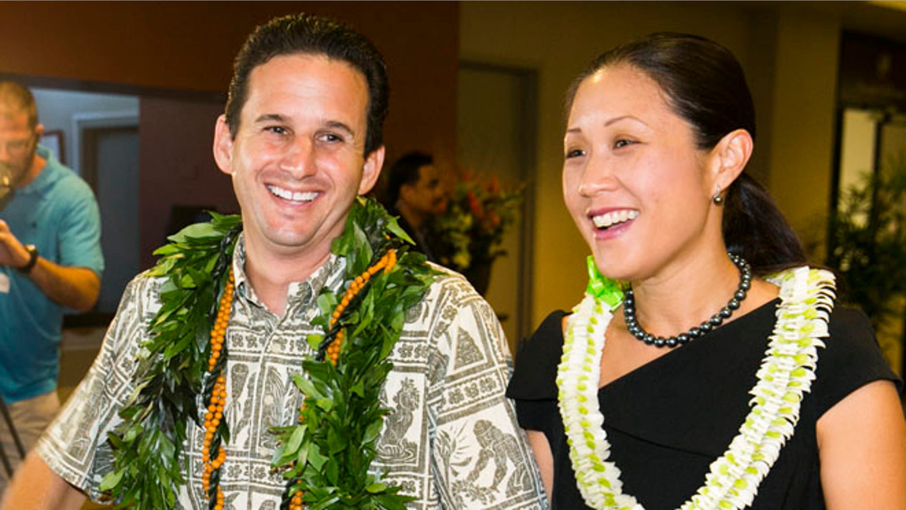 US Sen. Brian Schatz, left, and Linda Kwok Schatz attend the Democratic Unity Breakfast, Sunday, Aug. 10, 2014 in Honolulu.