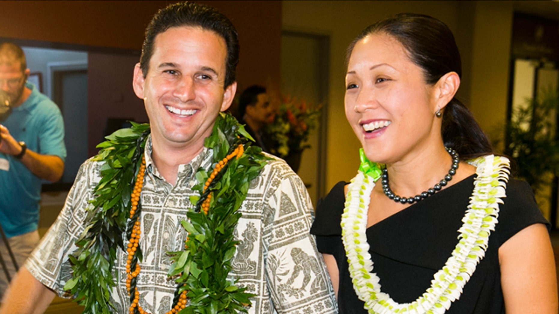 August 10, 2014: US Sen. Brian Schatz, left, and Linda Kwok Schatz attend the Democratic Unity Breakfast in Honolulu. The breakfast is traditionally held after Hawaii elections and is attended by both winners as well as losers. (AP Photo/Marco Garcia)