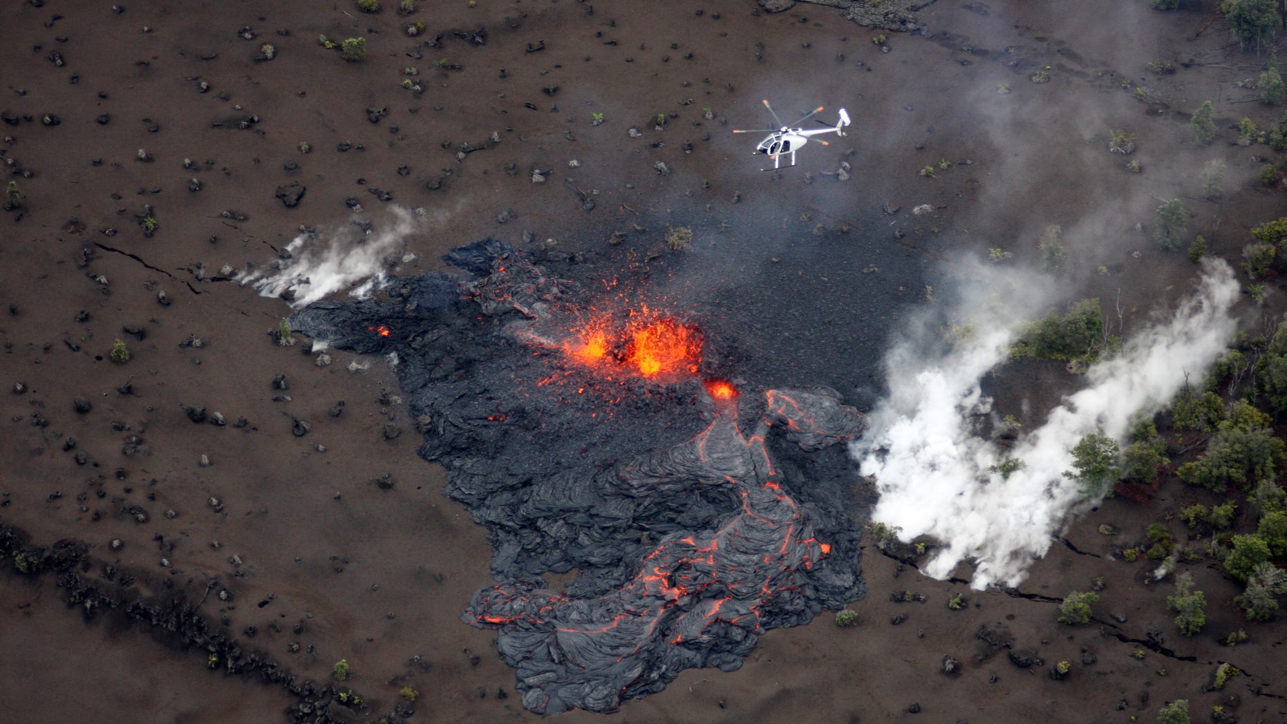 March 6: Scientists fly in a helicopter above the Pu'u O'o vent on Kilauea Volcano in Hawaii. Scientists say the Pu'u O'o crater floor has collapsed and an eruption occurred along the middle of Kilauea Volcano's east rift zone.