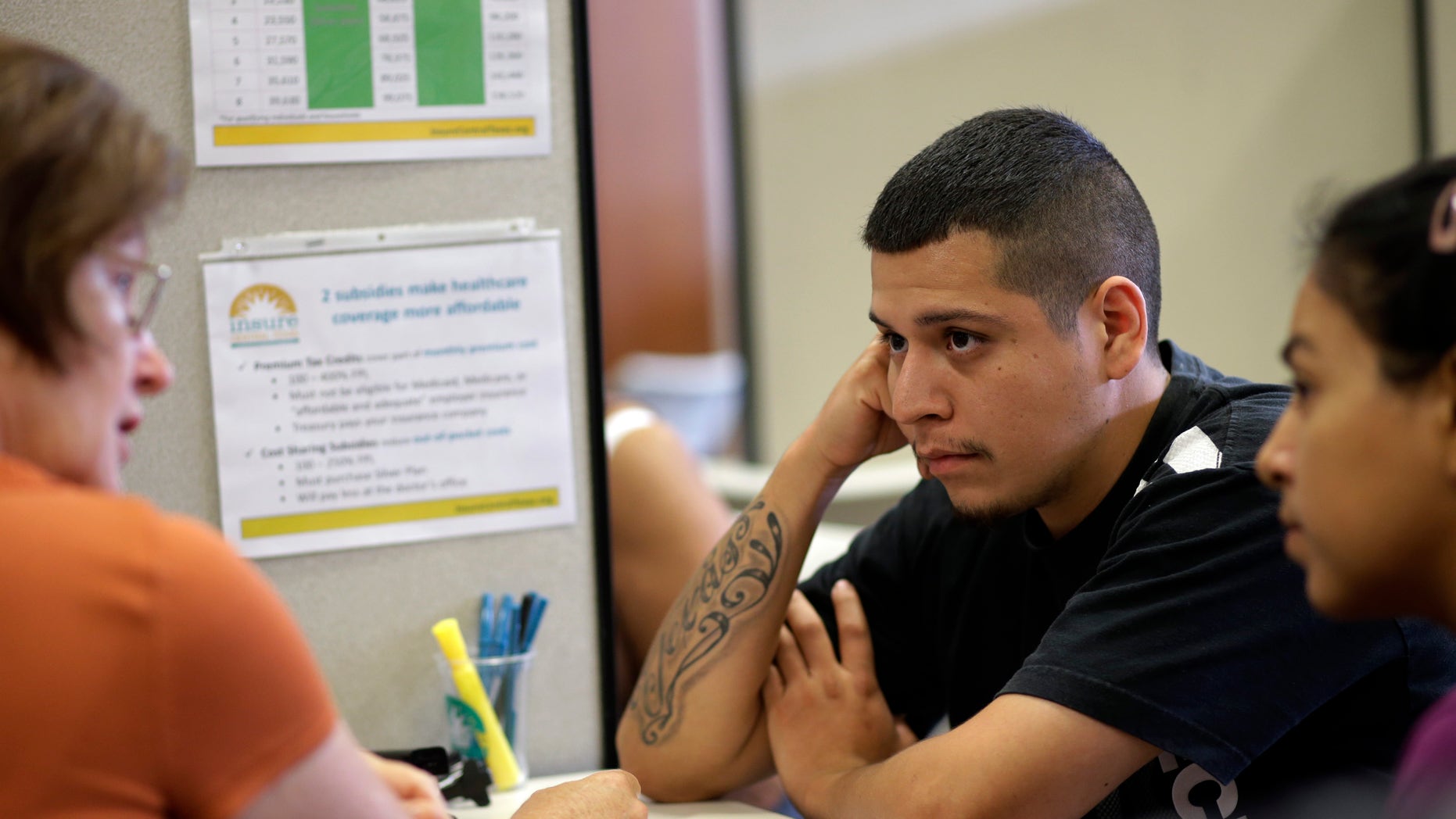 A volunteer counselor with Insure Central Texas explains health insurance options, Tuesday, Oct. 1, 2013.