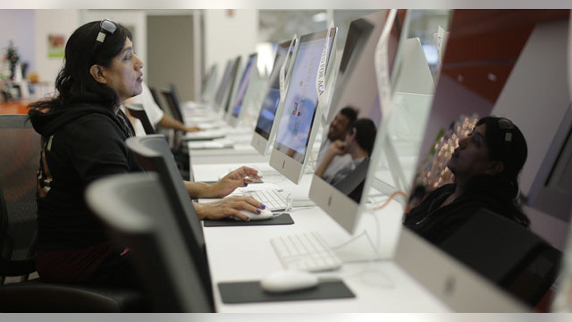 FILE - In this Dec. 11, 2013, file photo, Rosemary Cabelo uses a computer at a public library to access the Affordable Health Care Act website in San Antonio. (AP)