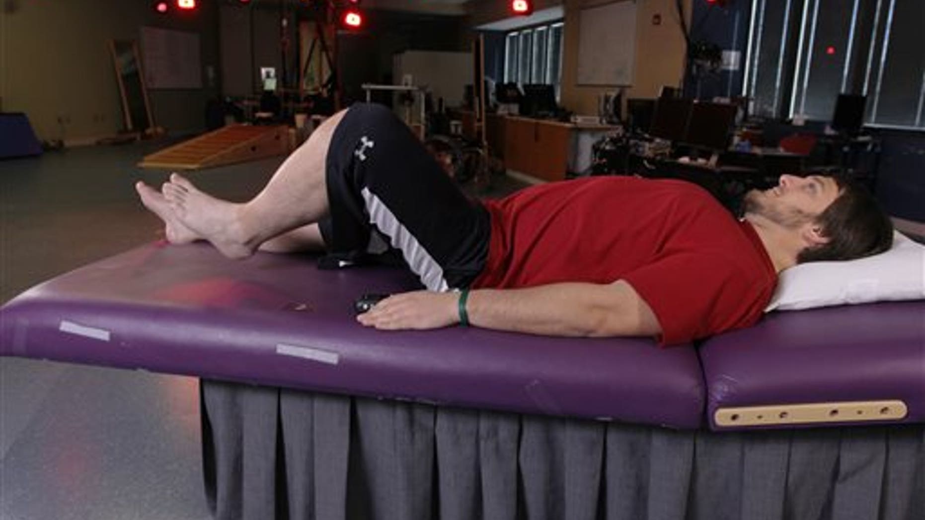 In this undated photo provided by the University of Louisville, Kent Stephenson, the second person to undergo epidural stimulation of the spinal cord, voluntarily raises his leg while stimulated at the Human Locomotion Research Center laboratory, a part of the University of Louisvilles Kentucky Spinal Cord Injury Research Center, Frazier Rehab Institute, in Louisville Ky. Three years ago, doctors reported that zapping a paralyzed mans spinal cord with electricity allowed him to stand and move his legs. Now theyve done the same with three more patients, suggesting their original success was no fluke. (AP Photo/University of Louisville)