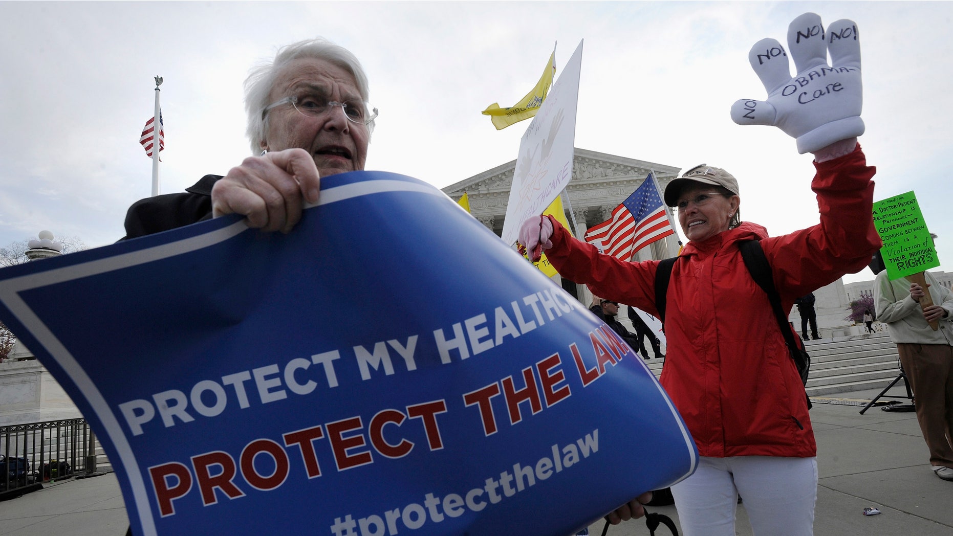 FILE: March 28, 2012: Obama healthcare legislation supporter Margot Smith (L) and legislation opponent Janis Haddon, of Georgia, outside the Supreme Court in Washington.