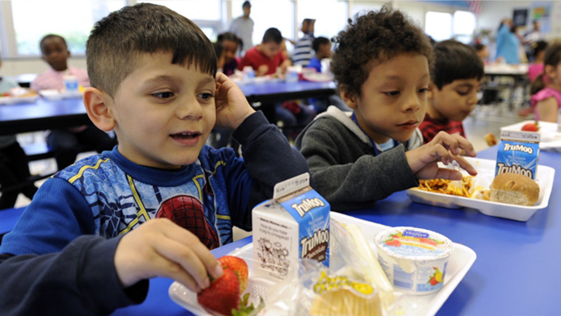 April 29, 2014: Biden Arias-Romers, 5, left, and Nathaniel Cossio-Boatwright, 6, right, eat lunch at the Patrick Henry Elementary School in Alexandria, Va. (AP Photo/Susan Walsh)
