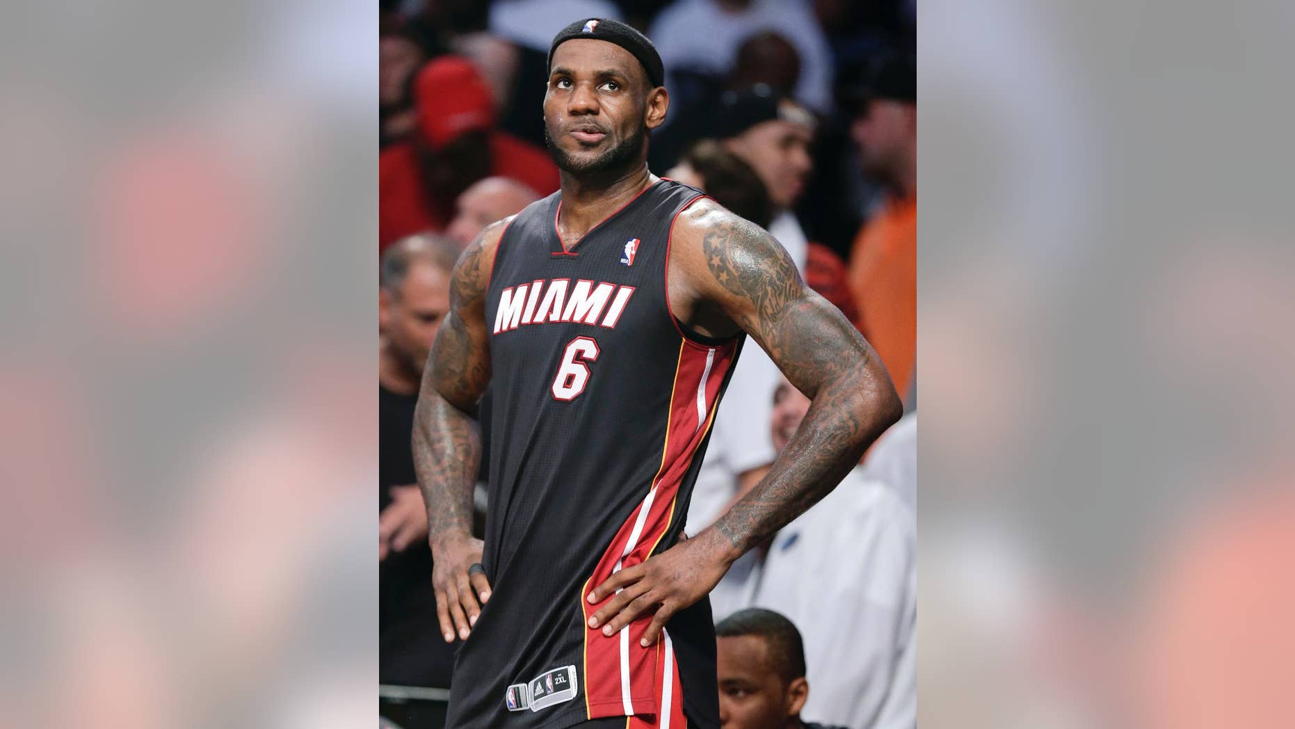 Miami Heat forward LeBron James (6) checks the scoreboard late in Game 3 of an Eastern Conference semifinal NBA playoff basketball game against the Brooklyn Nets, Saturday, May 10, 2014, in New York. The Nets won 104-90. (AP Photo/Julie Jacobson)