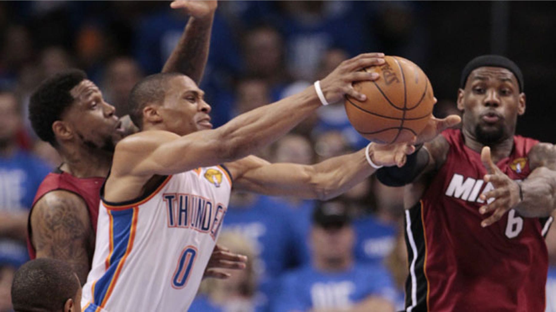 June 12, 2012: Oklahoma City Thunder point guard Russell Westbrook (0) grabs a rebound as Miami Heat power forward Udonis Haslem (40) and small forward LeBron James defend during the second half at Game 1 of the NBA finals basketball series in Oklahoma City.