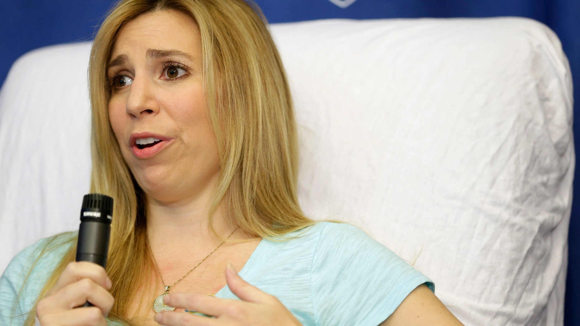 Heather Abbott, of Newport, R.I., responds to questions from reporters during a news conference at Brigham and Women's Hospital, in Boston. Abbott underwent a below the knee amputation during surgery on her left leg following injuries she sustained at the Boston Marathon bombings on April 15.