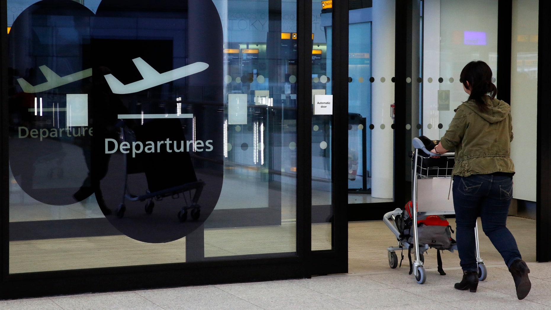 A passenger enters departures in Terminal 2 at Heathrow Airport in London July 3, 2014.