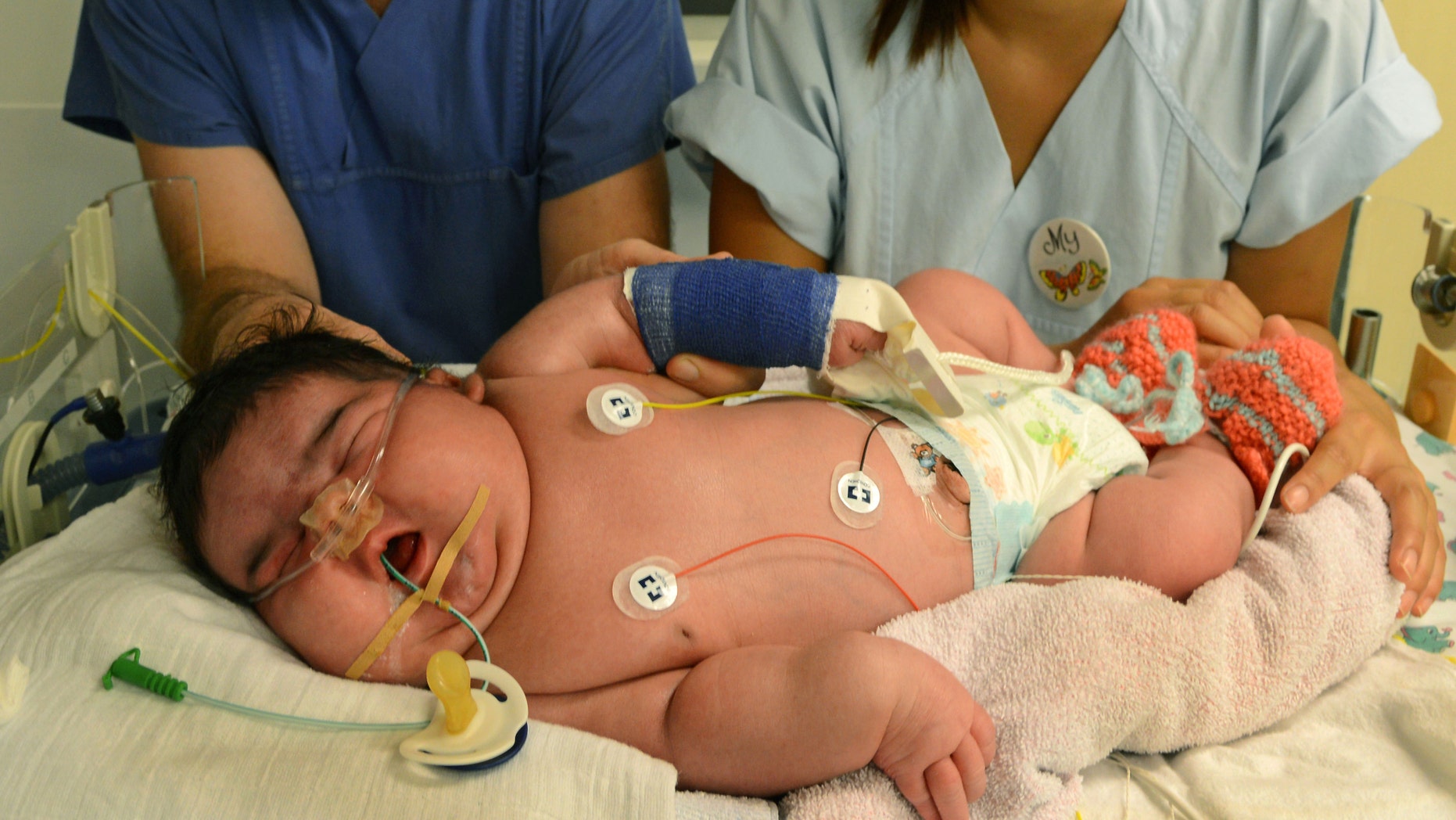 Consultant physician Matthias Knuepfer and nurse My take care of baby girl Jasleen, Germany's heaviest newborn until now, at the neonatal intensive care ward of the University Hospital in Leipzig, Germany.