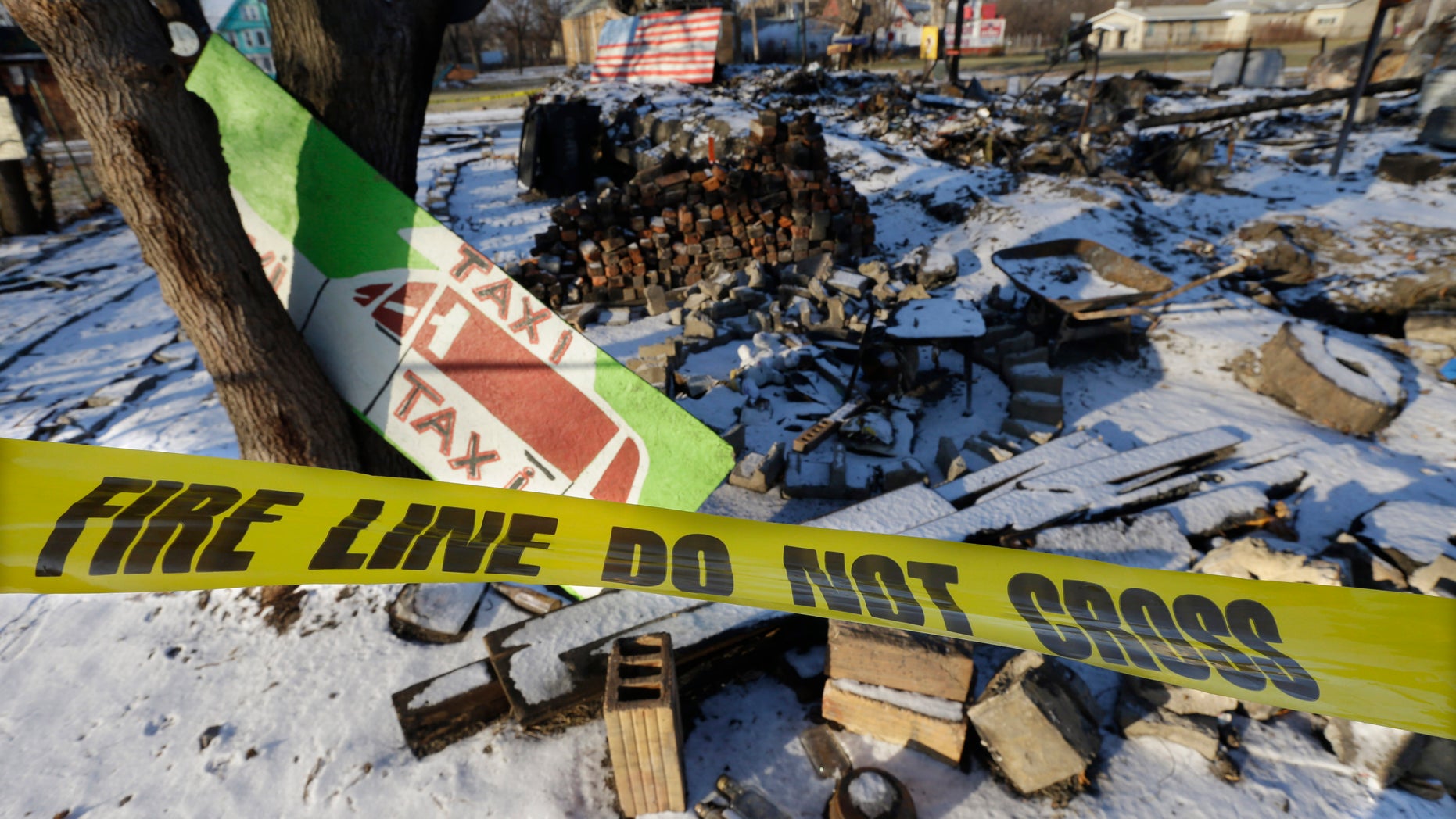 Dec. 10, 2013: In this photo taken at the Heidelberg Project in Detroit, fire tape is seen surrounding the aftermath of the fire at the House of Soul.