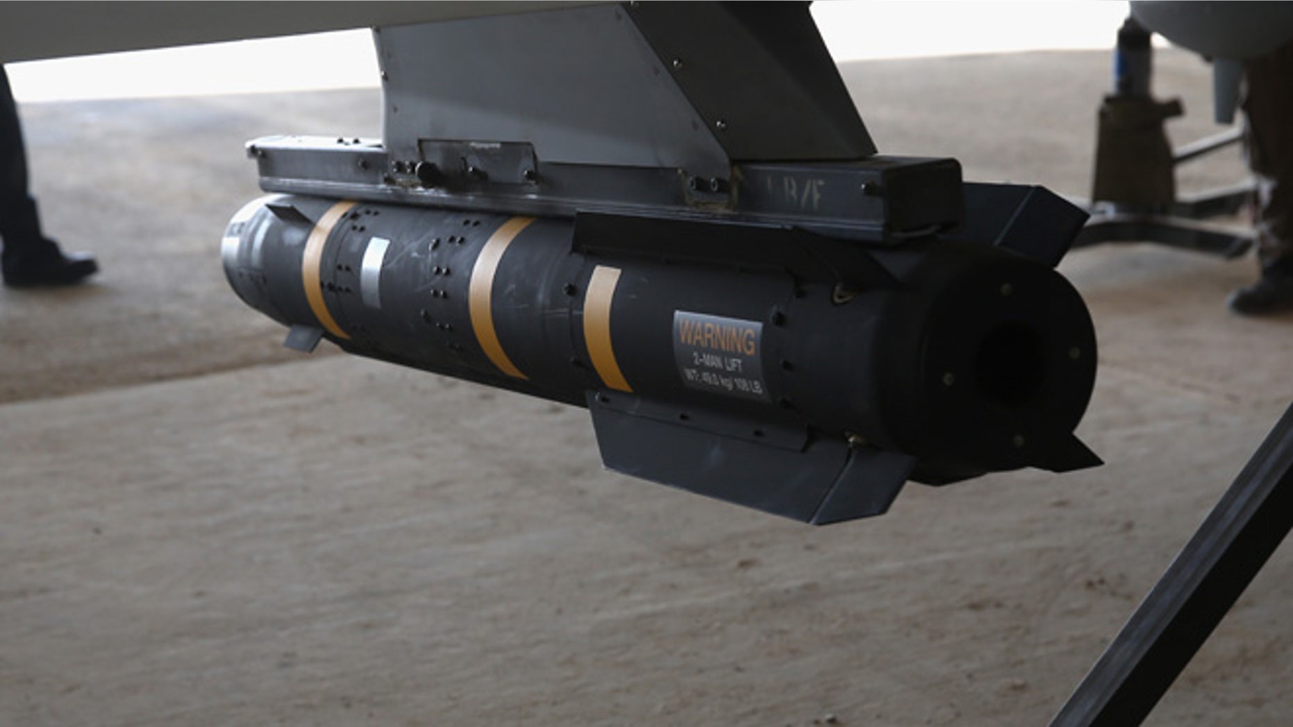 A Hellfire missile hangs from a U.S. Air Force MQ-1B Predator unmanned aerial vehicle (UAV), at a secret air base in the Persian Gulf region on January 7, 2016. (Photo by John Moore/Getty Images)