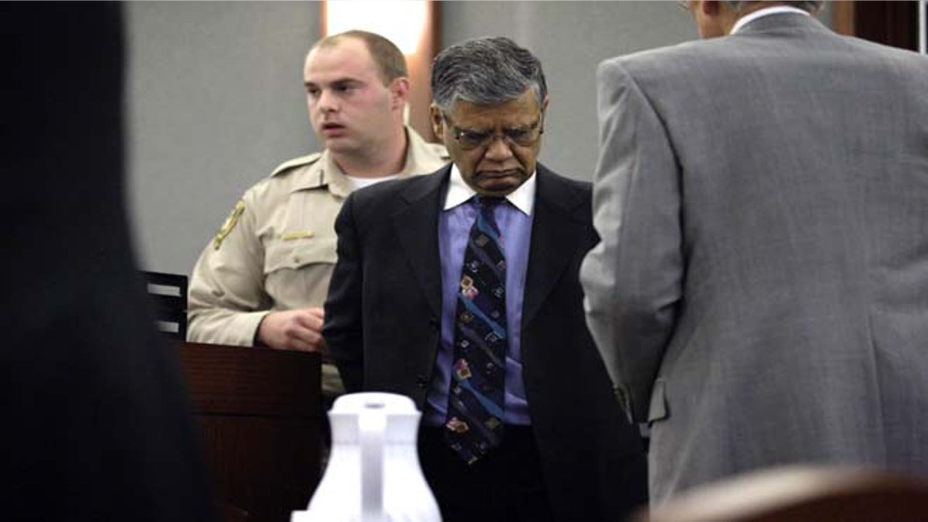 July 1, 2013: Former doctor and endoscopy clinic owner Dipak Desai right, is taken into custody by Clark County marshals at the Regional Justice Center in Las Vegas Monday, July 1, 2013 after a jury found him guilty. Nevada state court jury found Desai guilty of all 27 criminal charges against him— including second-degree murder — in a 2007 hepatitis C outbreak that officials called one of the largest ever in the U.S. (AP Photo/Las Vegas Review-Journal, Jessica Ebelhar)