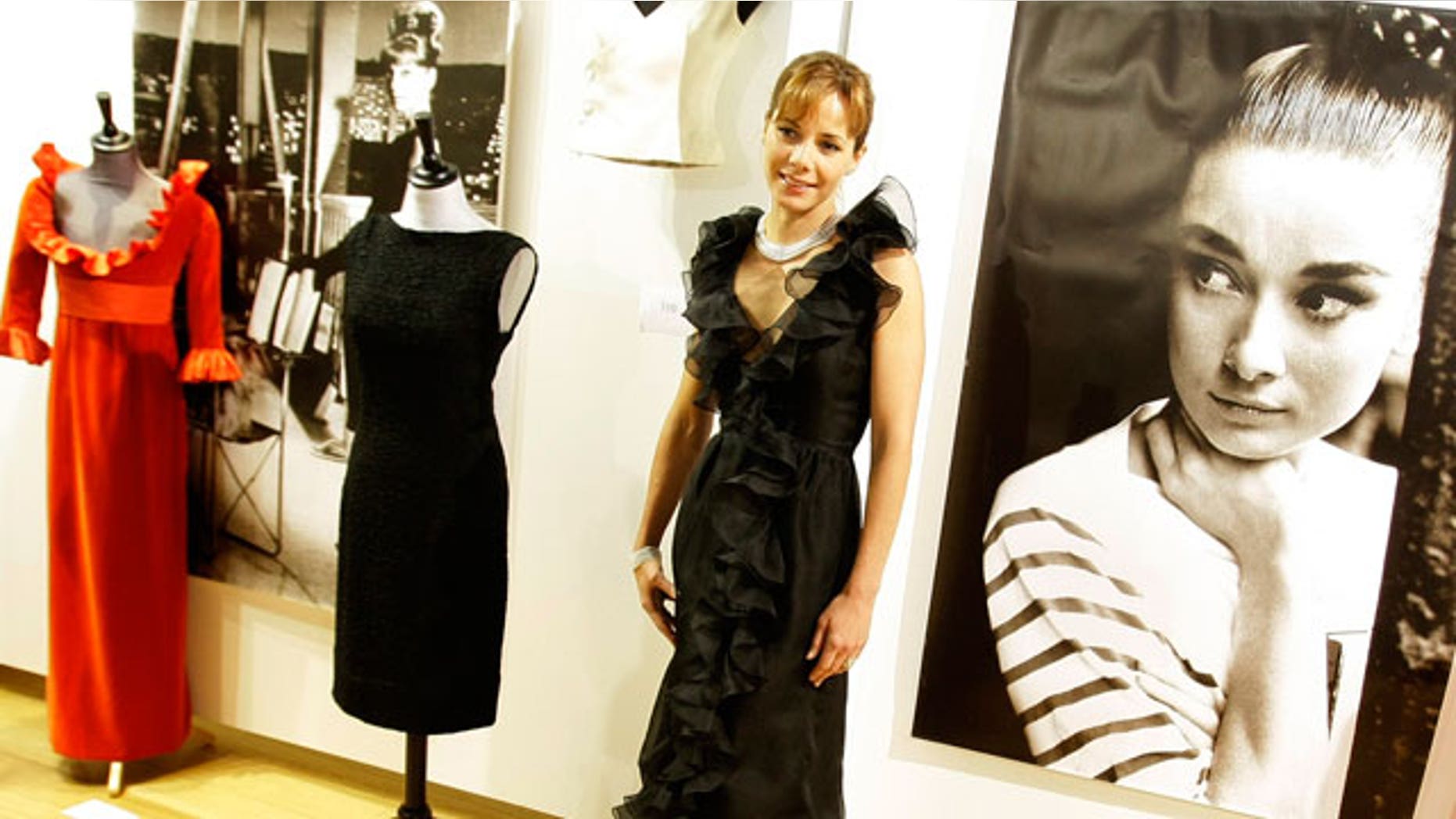 Dec. 7: Former British ballerina Darcey Bussell models a black Valentino haute couture black organza ruffle edge cocktail dress from 1971, in London.