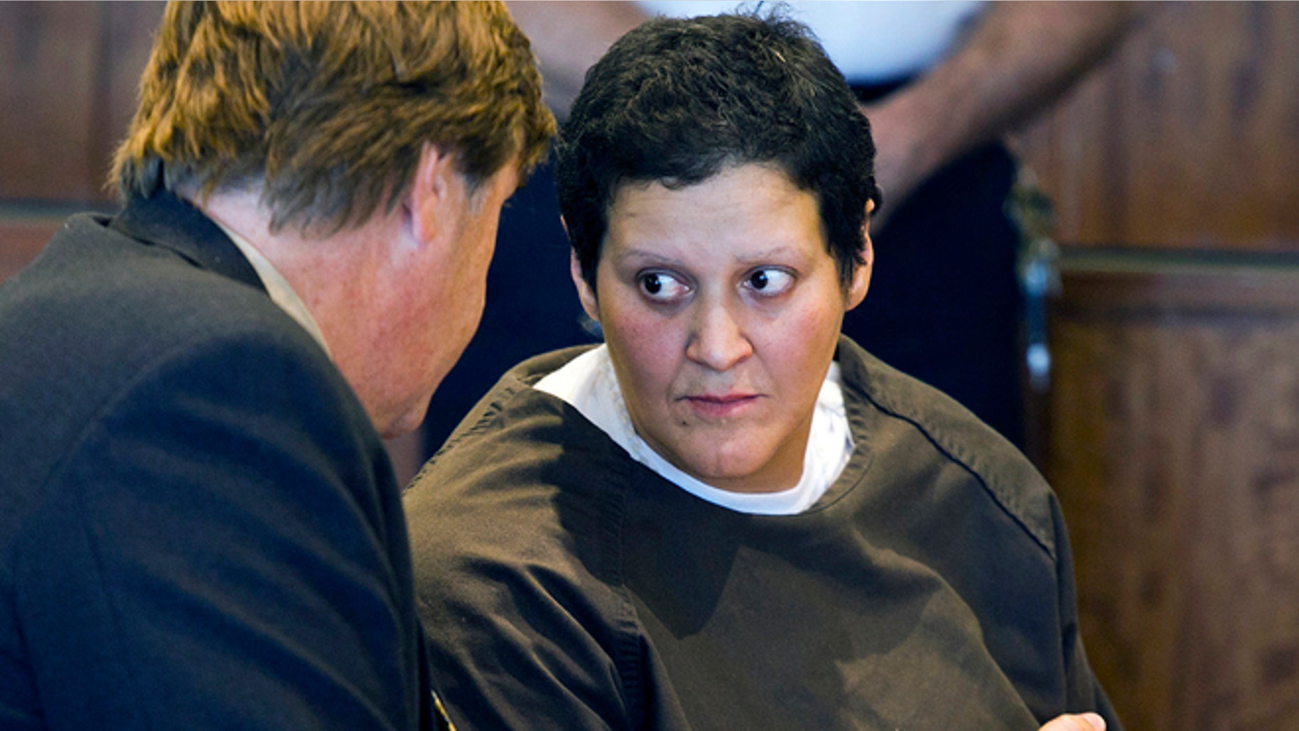 FILE - In this Oct. 24, 2013 file photo, Tanya Singleton, right, cousin of former New England Patriots football player Aaron Hernandez, speaks with defense attorney Peter Parker during a bail hearing at Superior Court in Fall River, Mass. Singleton was released on bail Thursday, Jan. 30, 2013, more than five months after her indictment on two charges in connection with the murder case against Hernandez. (AP Photo/Boston Herald, Dominick Reuter, Pool, File)