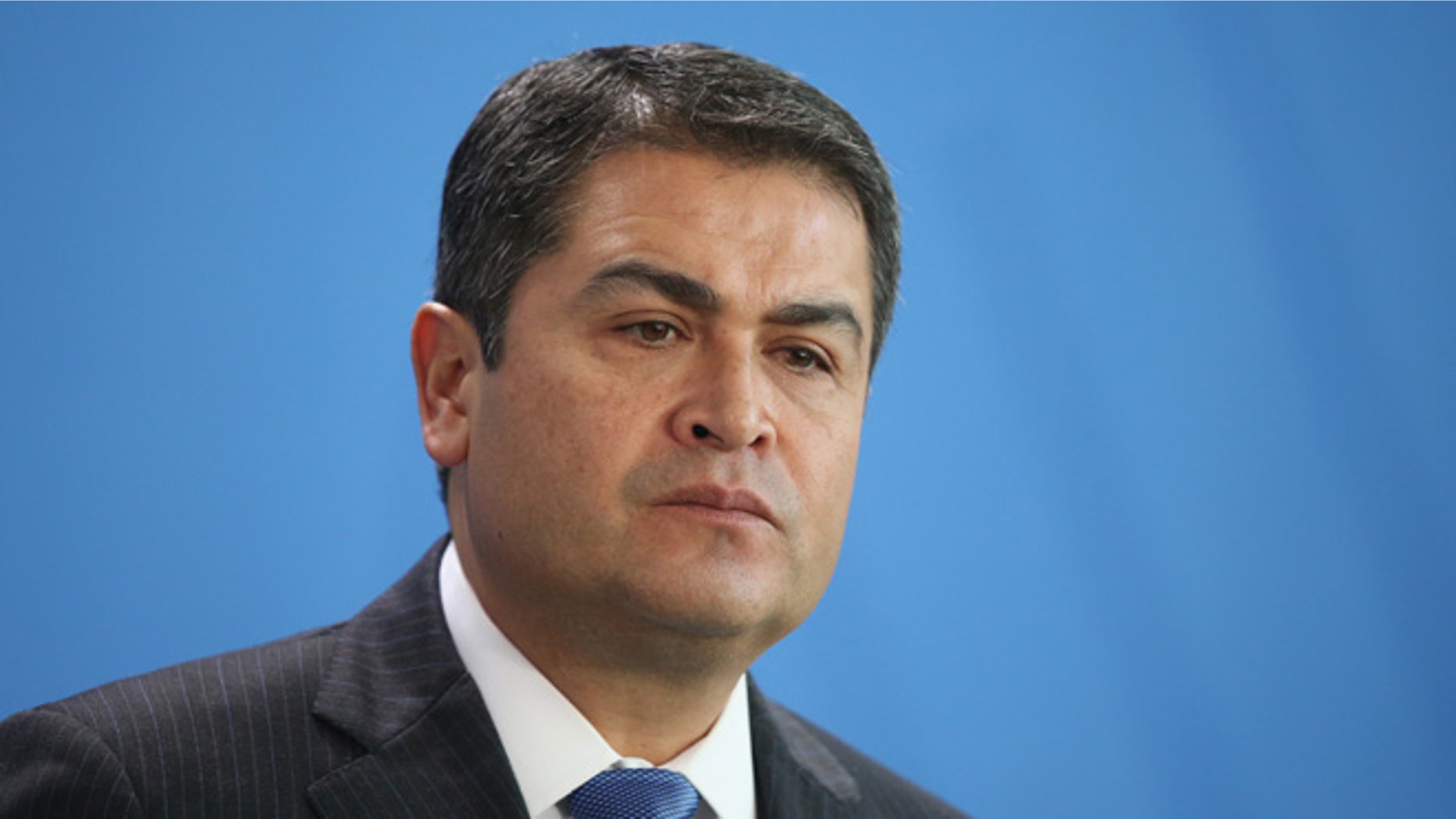 BERLIN, GERMANY - OCTOBER 27: Honduran President Juan Orlando Hernandez speaks to the media with German Chancellor Angela Merkel (not pictured) following talks at the Chancellery on October 27, 2015 in Berlin, Germany. The two leaders discussed a variety of environmental, economic, political and law enforcement issues. (Photo by Sean Gallup/Getty Images)