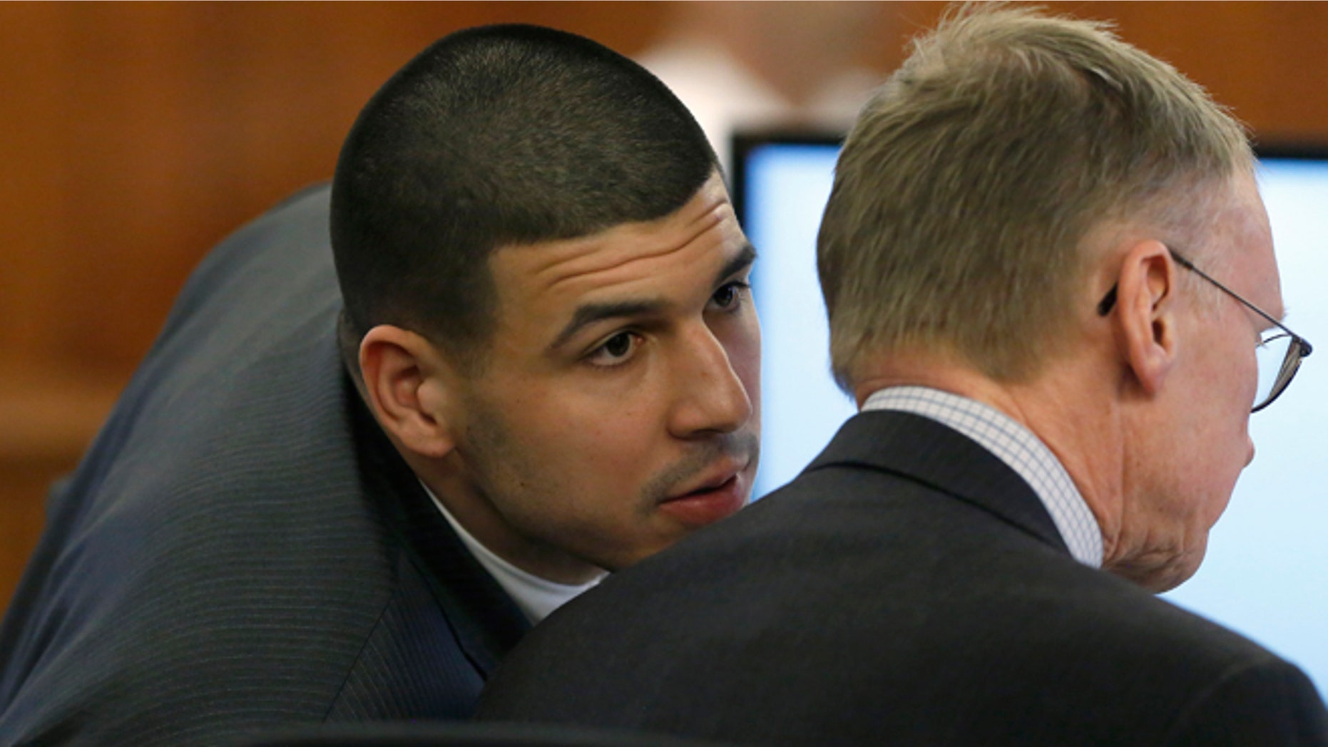 Former New England Patriots football player Aaron Hernandez, left, speaks with his defense attorney Charles Rankin, right, during his murder trial Thursday, March 12, 2015, in Fall River, Mass. Hernandez is charged with killing semiprofessional football player Odin Lloyd. (AP Photo/Steven Senne, Pool)