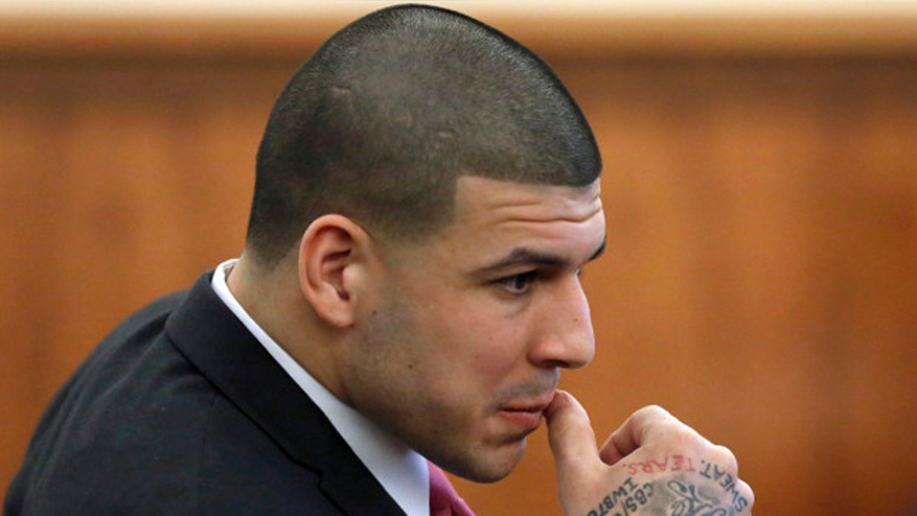Former New England Patriots NFL football player Aaron Hernandez is seated during his murder trial, Thursday, April 2, 2015, in Fall River, Mass. Hernandez is charged with killing Odin Lloyd in June 2013. (AP Photo/Steven Senne, Pool)