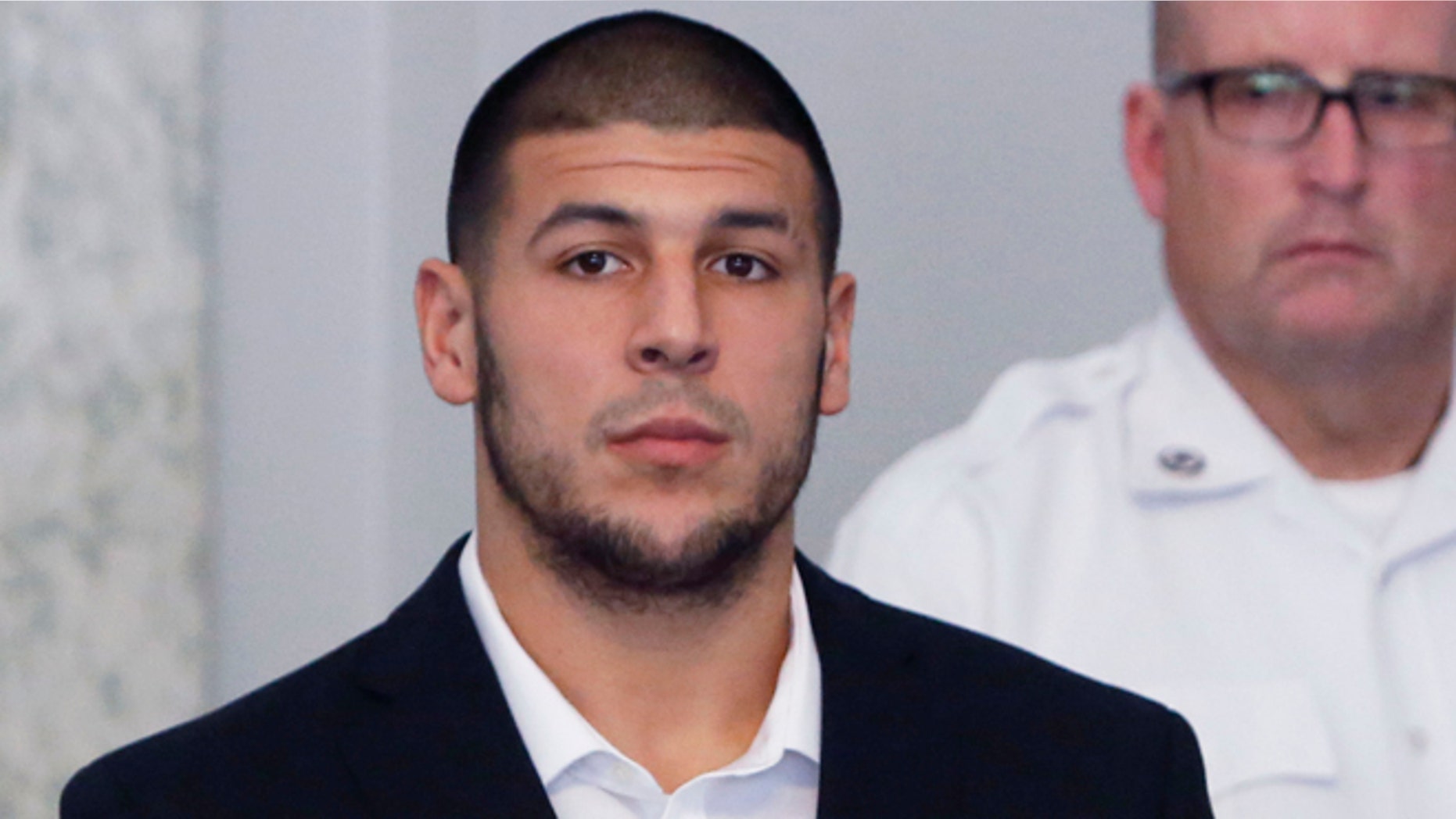 FILE - In this Wednesday, July 24, 2013 file photo, former New England Patriots NFL football tight end Aaron Hernandez appears during a probable cause hearing at Attleboro District Court, in Attleboro, Mass. Hernandez was indicted Thursday, Aug. 22, 2013, on a first-degree murder charge in the death of a friend whose bullet-riddled body was found in an industrial park about a mile from the ex-player's home. (AP Photo/Bizuayehu Tesfaye, File)