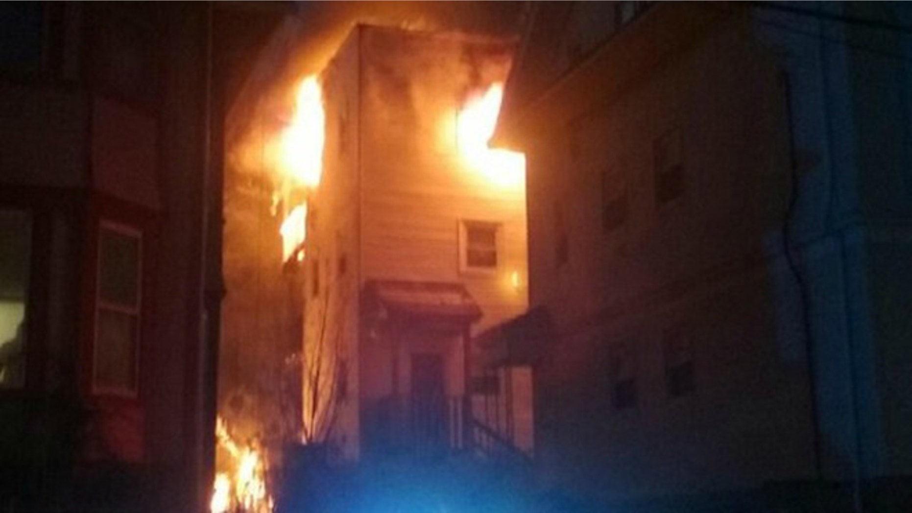 The burning townhouse in Dorchester where Officer Luis Lopez helped saved 18 residents. (Photo: MyFoxBoston)