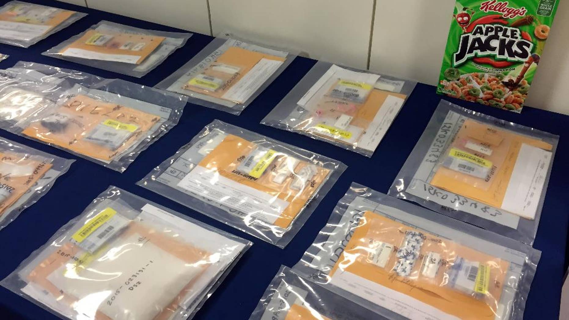 Packages of heroin fill a table during a news conference at the Brooklyn District Attorney’s Office in New York, Thursday, Sept. 17, 2015. A family-run heroin ring brought in more than $1.5 million in 2014 by using cereal boxes to conceal the drugs, which were sold to distributors including a court employee and a drug counselor, a district attorney said Thursday in announcing the arrests of two dozen people. (AP Photo/Michael Balsamo)