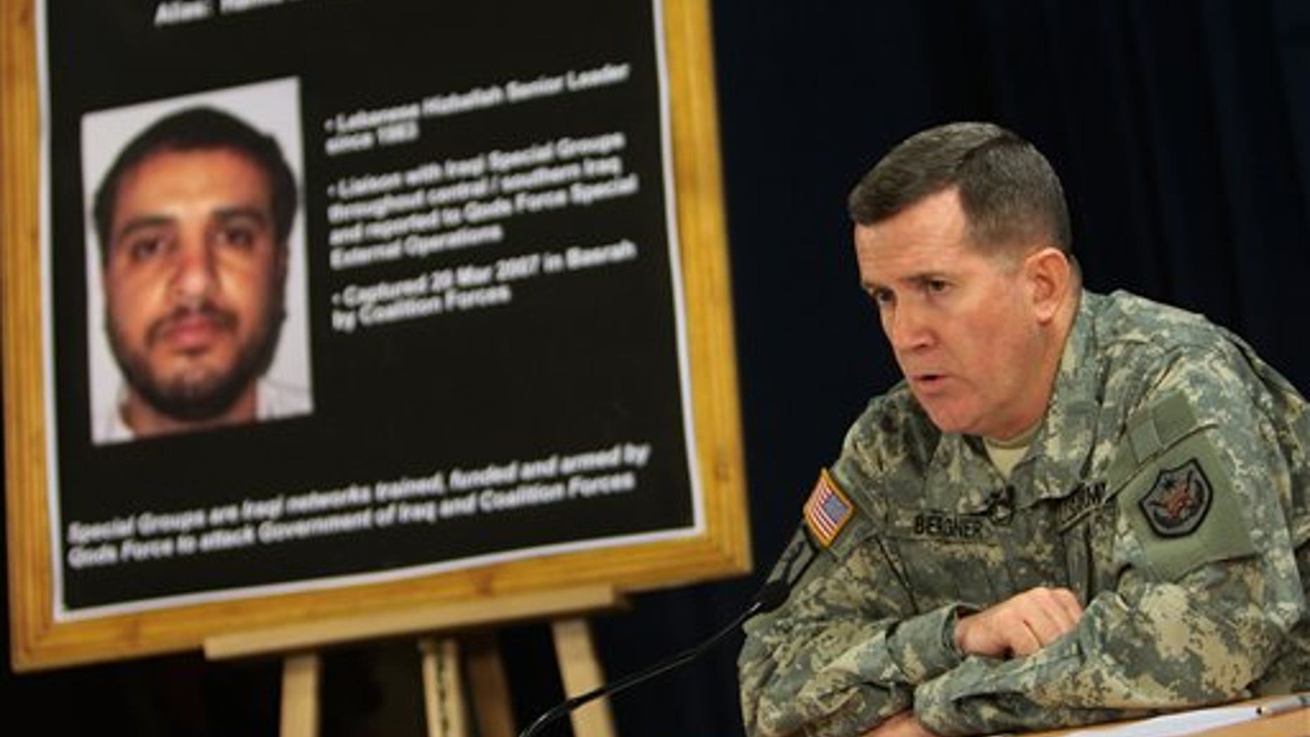 July 2, 2007: U.S. military spokesman Brig. Gen. Kevin J. Bergner speaks in Baghdad near a poster of senior Hezbollah operative Ali Musa Daqduq.