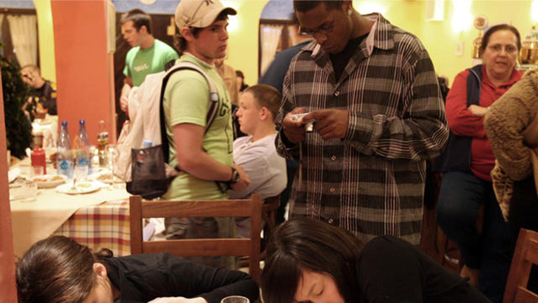 High school students of Chapel Hill high school in North Carolina, rest at a restaurant, after being rescued from a Greek cruise ship off the island of Santorini, Thursday, April 5, 2007. Nearly 1,600 passengers and crew were rescued from the Sea Diamond cruise ship after it struck rocks and took on water. No one was injured in the incident. Most passengers were from the United States, Canada and Spain. (AP Photo/Thanassis Stavrakis)