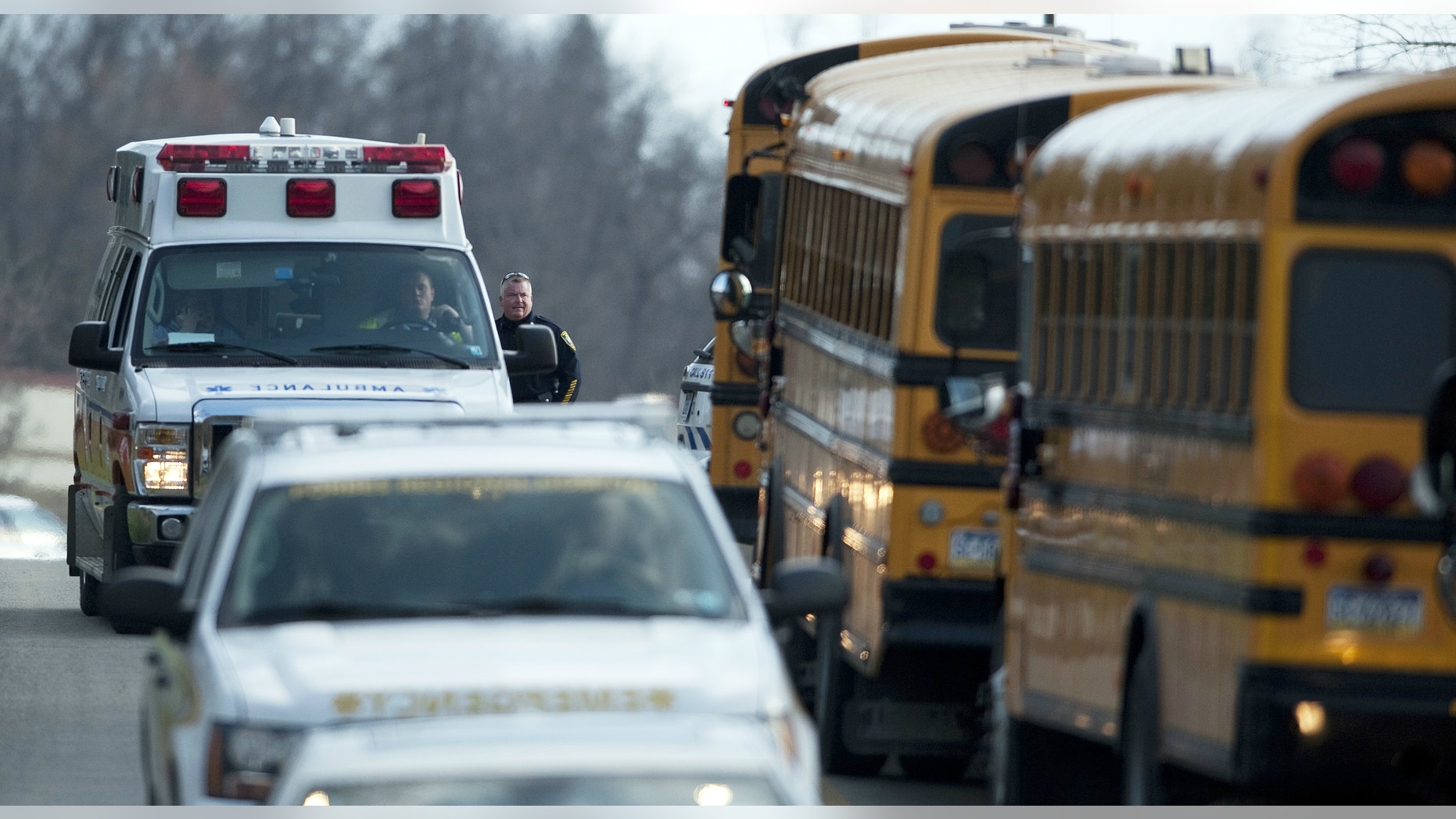 An ambulance and emergency vehicles leave Franklin Regional High School where more then a dozen students were stabbed by a knife wielding suspect on Wednesday, April 9, 2014, in Murrysville, Pa., near Pittsburgh.