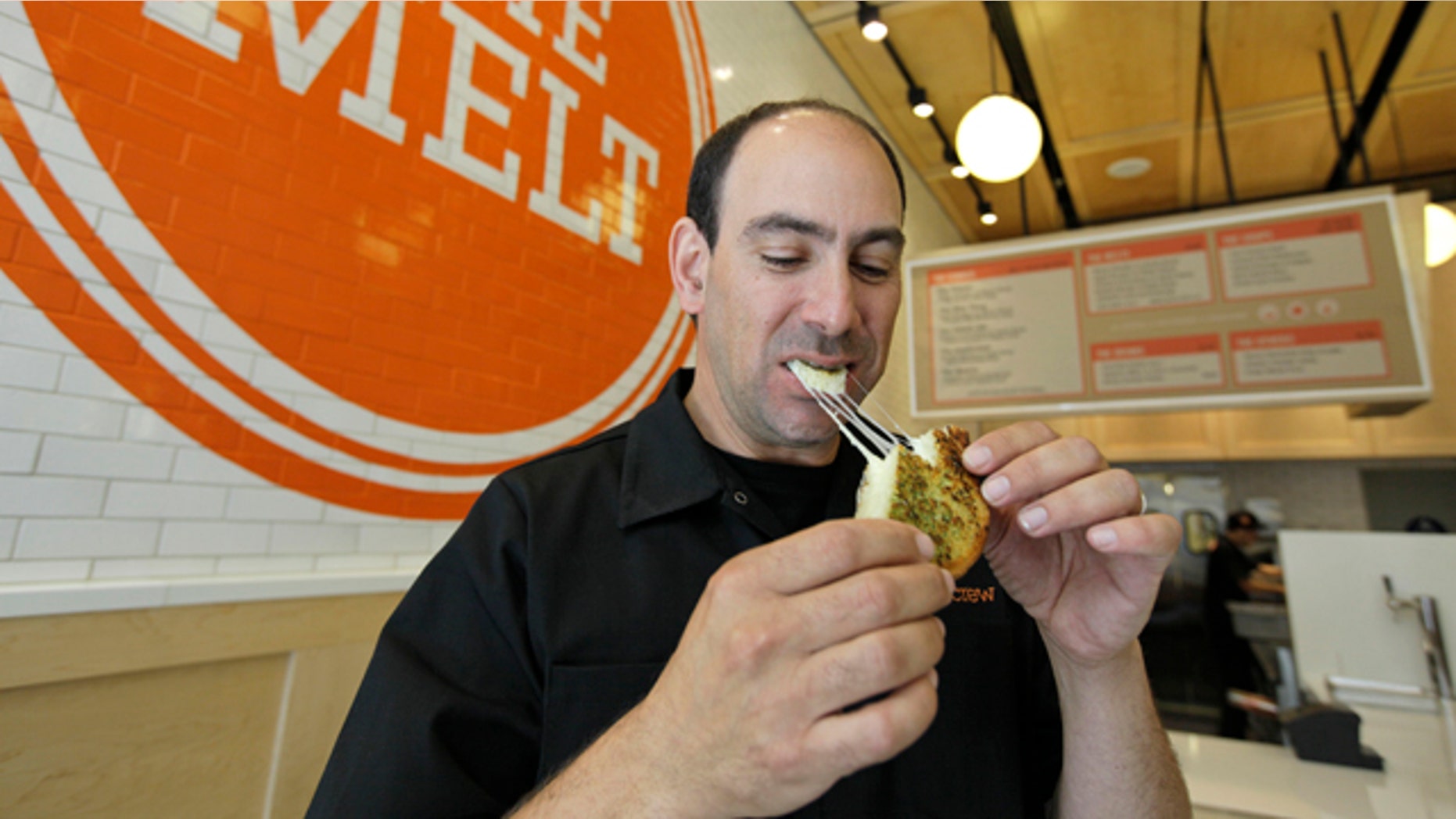 Aug. 25, 2011: Jonathan Kaplan bites into a melt called the Italian Job made with fontina and provolone cheese on garlic bread at The Melt in San Francisco. First, Flip Video camcorder creator Kaplan made it easy for consumers to shoot cheesy home movies. Now, hes hoping to popularize something cheesier and gooier by starting a grilled cheese restaurant business that combines fast food with high tech.