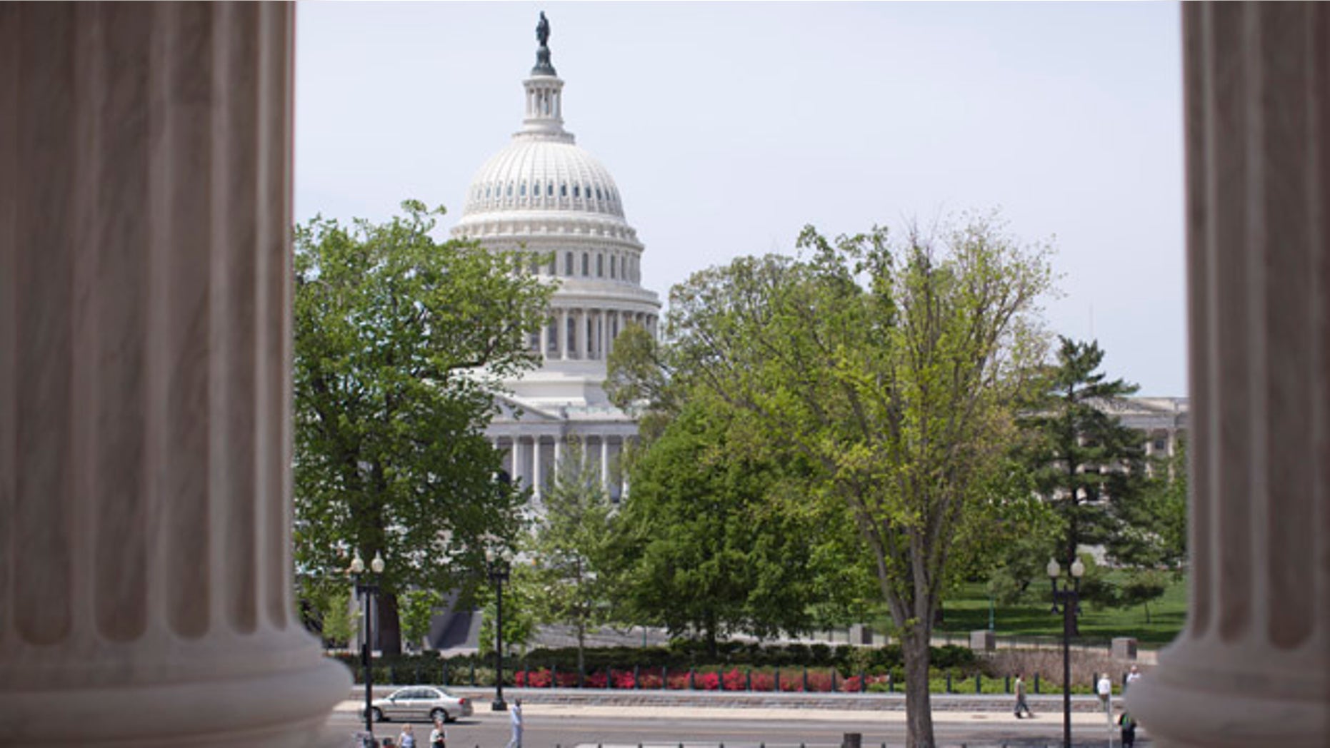 FILE - In this May 5, 2014, file photo, the U.S. Capitol building is seen through the columns on the steps of the Supreme Court in Washington. (AP Photo/Carolyn Kaster, File)