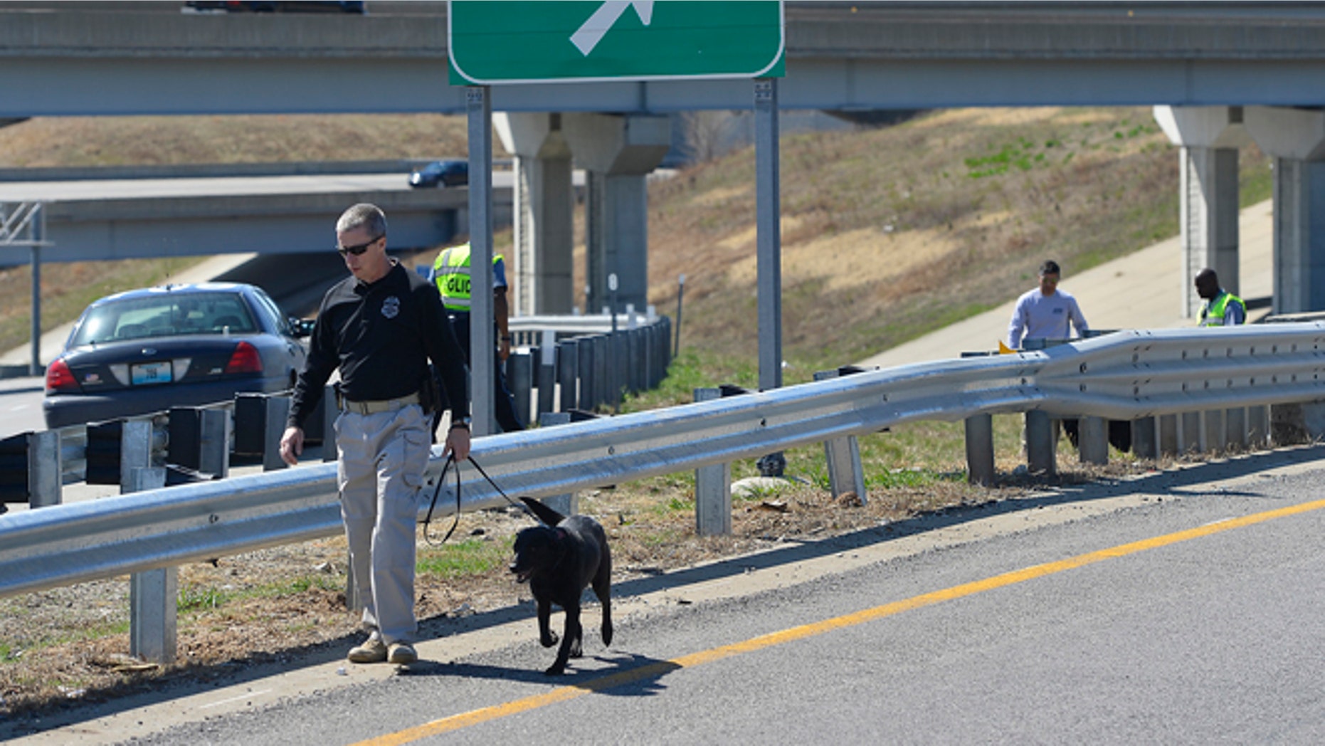 APRIL 9: Kansas City police and agents from the Alcohol, Tobacco and Firearms with canines investigated a shooting along southbound Interstate 435 in Kansas City, Mo.