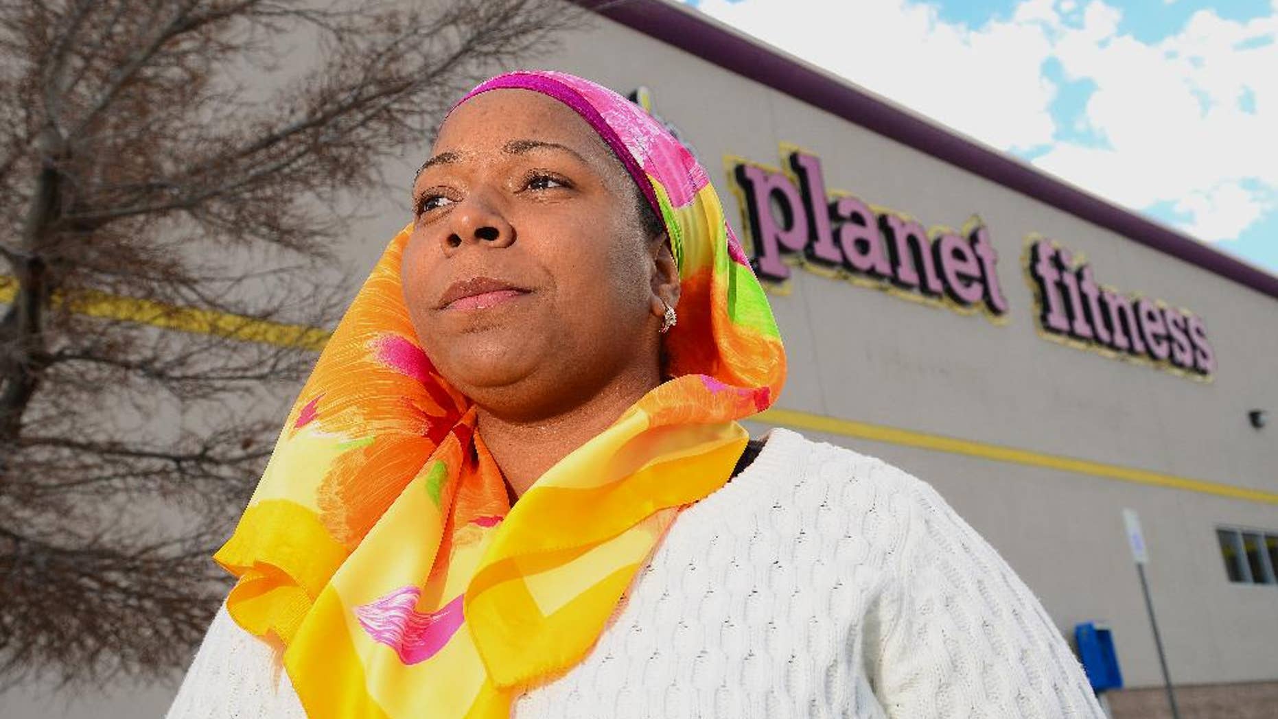 Tarainia McDaniel is photographed in front of Planet Fitness in Albuquerque, N.M., March 2, 2014. The Albuquerque Planet Fitness refused to let McDaniel a New Mexico Muslim woman, wear her religious head covering when she tried to work out, according to a new lawsuit. An attorney for McDaniel, 37, recently filed the lawsuit in a New Mexico district court stemming after a 2011 clash that prevented McDaniel from using the gym, even though court documents said another Planet Fitness had previously let her. (AP Photo/The Albuquerque Journal, Adolphe Pierre-Louis)