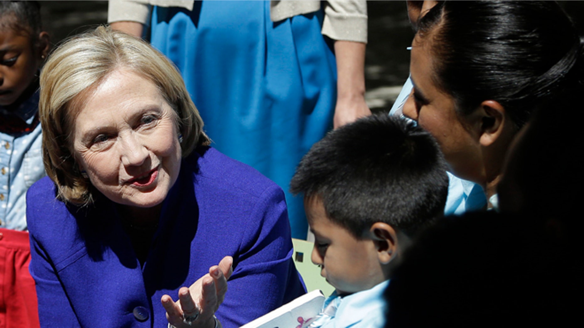 Hillary Clinton talks with families that are participating in the "Talking is Teaching: Talk Read Sing"campaign at the Children's Hospital Oakland Research Institute on July 23, 2014 in Oakland, California. (Photo by AP Photo/Getty Images)
