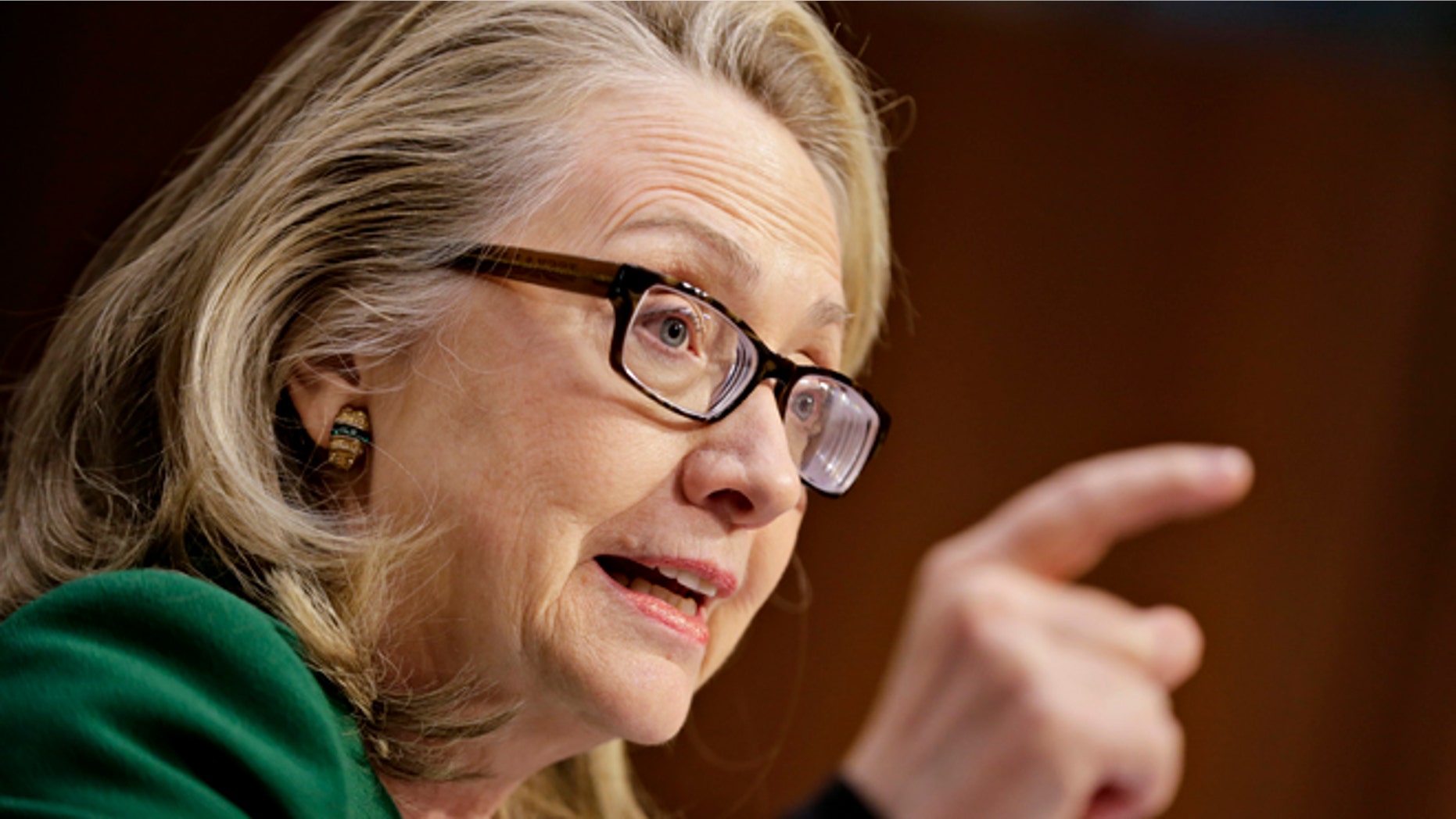 Secretary of State Hillary Rodham Clinton pounds her fist as she testifies on Capitol Hill in Washington, Wednesday, Jan. 23, 2013, before the Senate Foreign Relations Committee hearing on the deadly September attack on the U.S. diplomatic mission in Benghazi, Libya, that killed Ambassador Chris Stevens and three other Americans. (AP Photo/J. Scott Applewhite)
