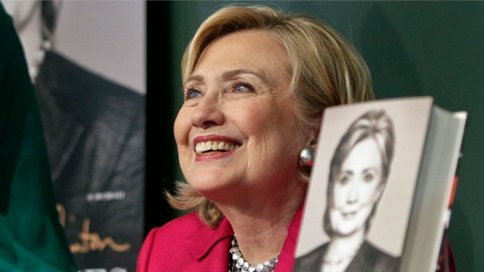 HiIlary Clinton listens before signing a copy of her book, Hard Choices, on Tuesday June 10, 2014, at Barnes and Noble bookstore in New York.