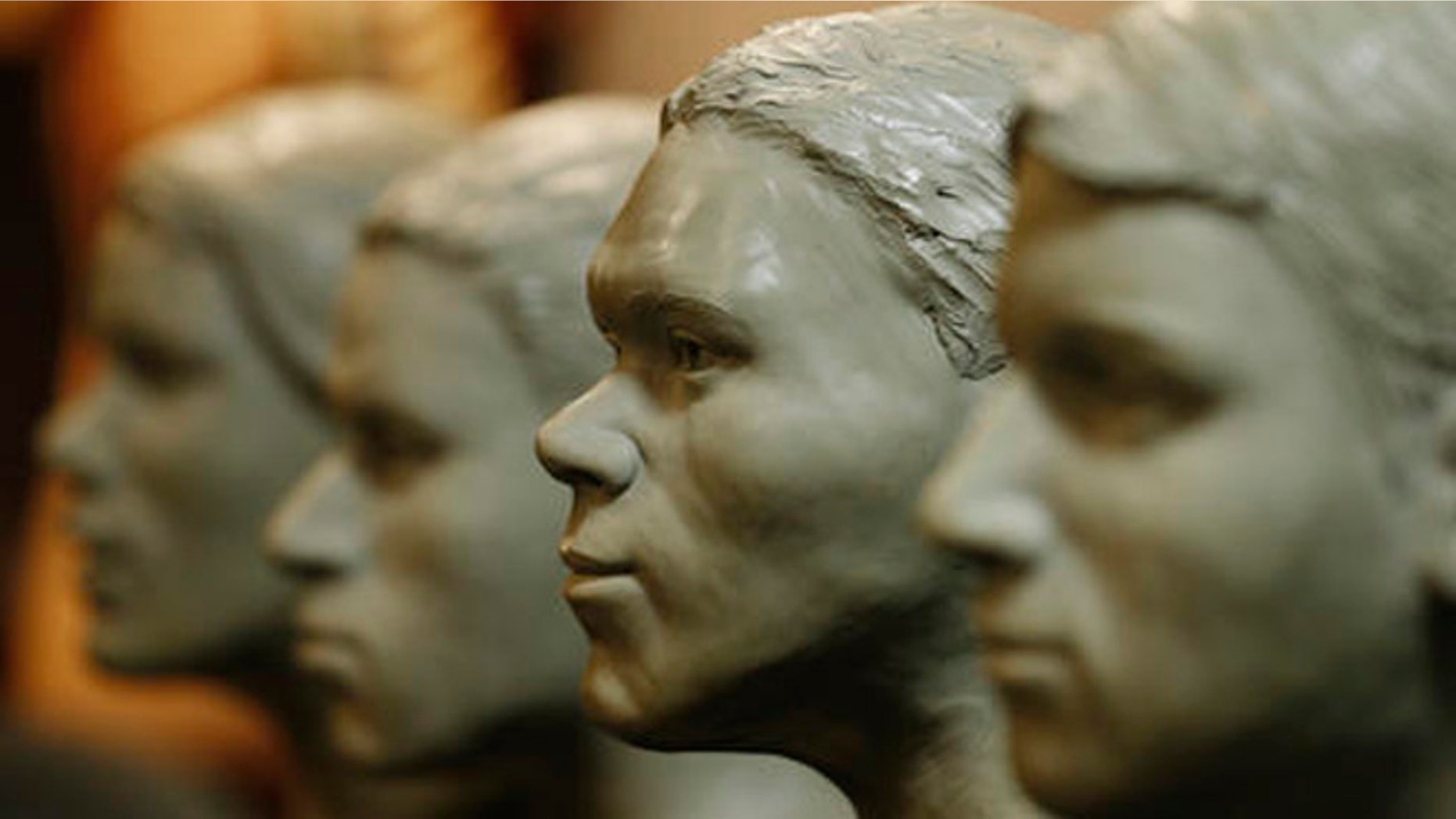 Busts of unidentified crime victims are lined up in the offices of the Chief Medical Examiner for Virginia Tuesday, March 15, 2016, in Richmond, Va. The medical examiner's office is hoping a new set of facial sculptures created by the FBI will help identify eight people found dead in Virginia between 1972 and 2014. (AP Photo/Steve Helber)
