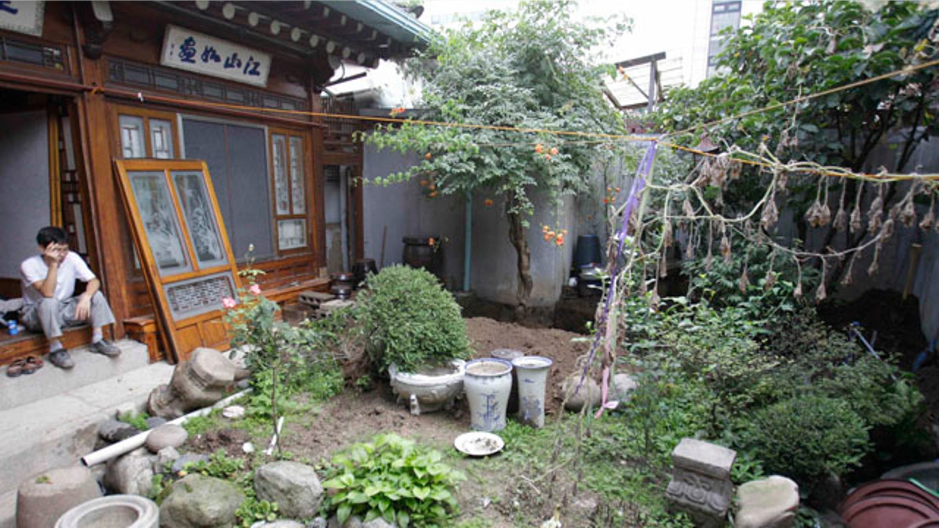 August 21: A South Korean worker takes a rest as he demolishes the Ojinam, Seoul's last restaurant of its kind and one of the city's most famous examples of traditional Korean architecture, in Seoul, South Korea. (AP)